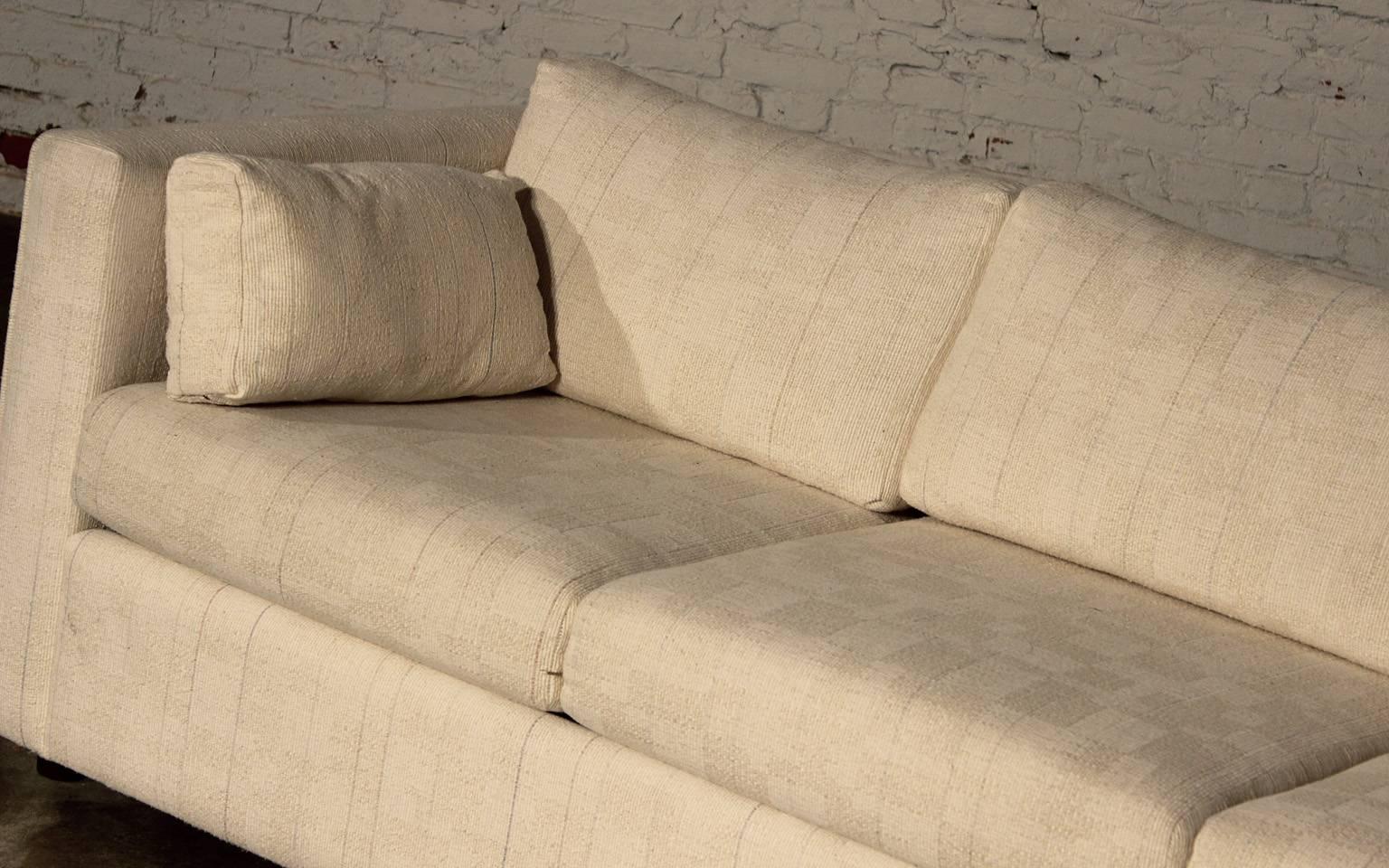 Great Mid-Century Modern sleeper sofa or hide-a-bed in neutral white nubby fabric and tuxedo styling. It is in wonderful vintage condition.

With the trend toward small homes and loft living this awesome Mid-Century Modern sleeper sofa is just
