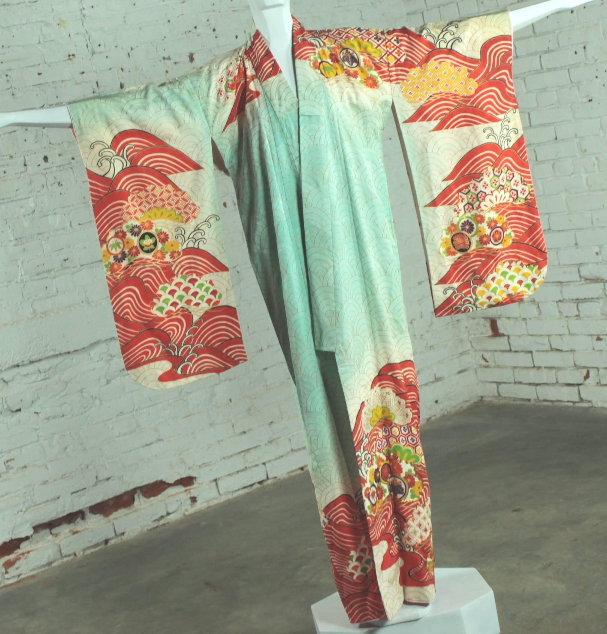 Gorgeous vintage silk full length Japanese kimono in turquoise, orange, red, yellow, green, gold and purple. It is in wonderful wearable condition.

This wearable work of art is incredible! Gorgeous Japanese full length kimono in vibrant turquoise