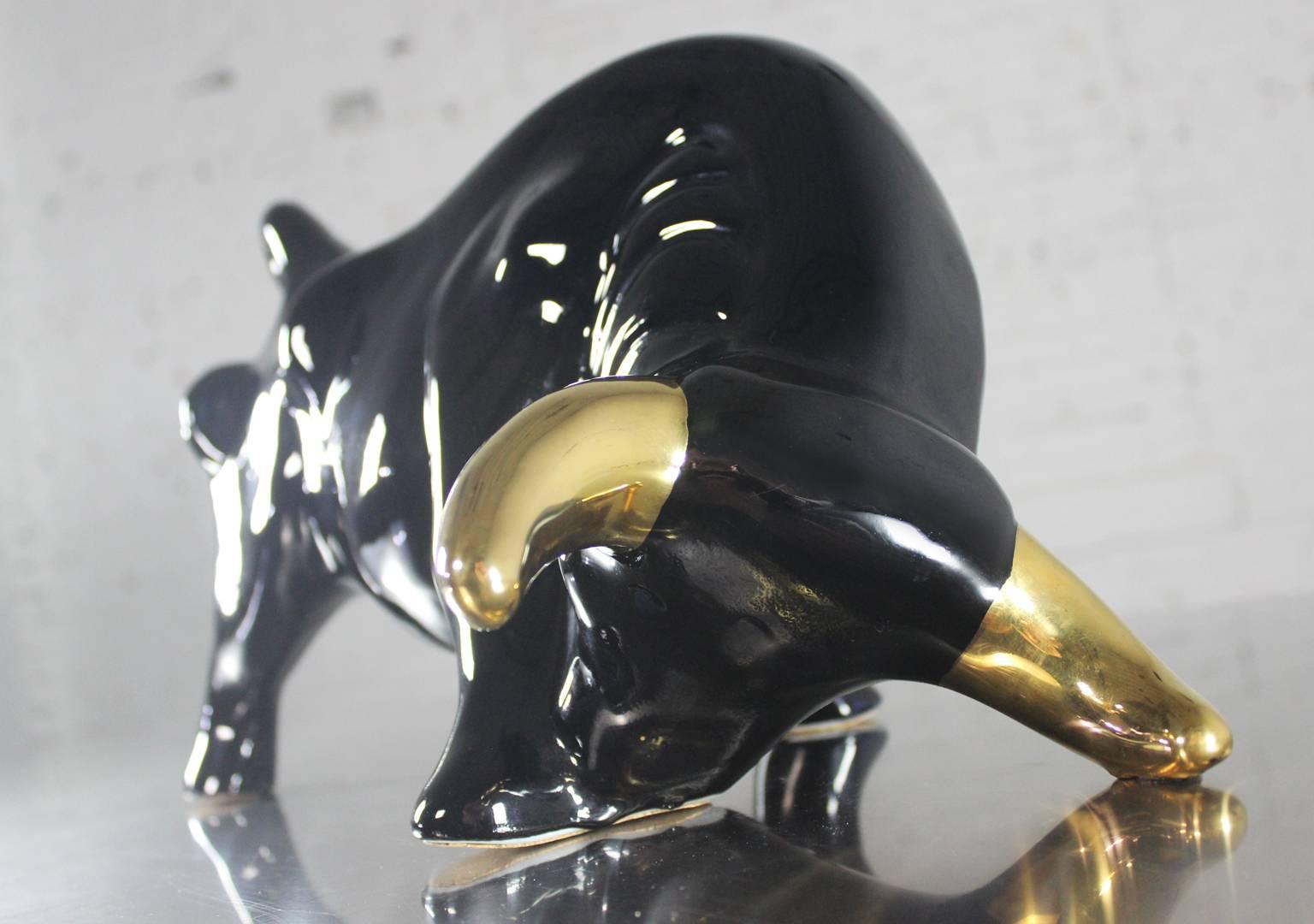 Figural art pottery bull by Vanguard Studios. Black with 22-karat gold accents. Paper labels stating 