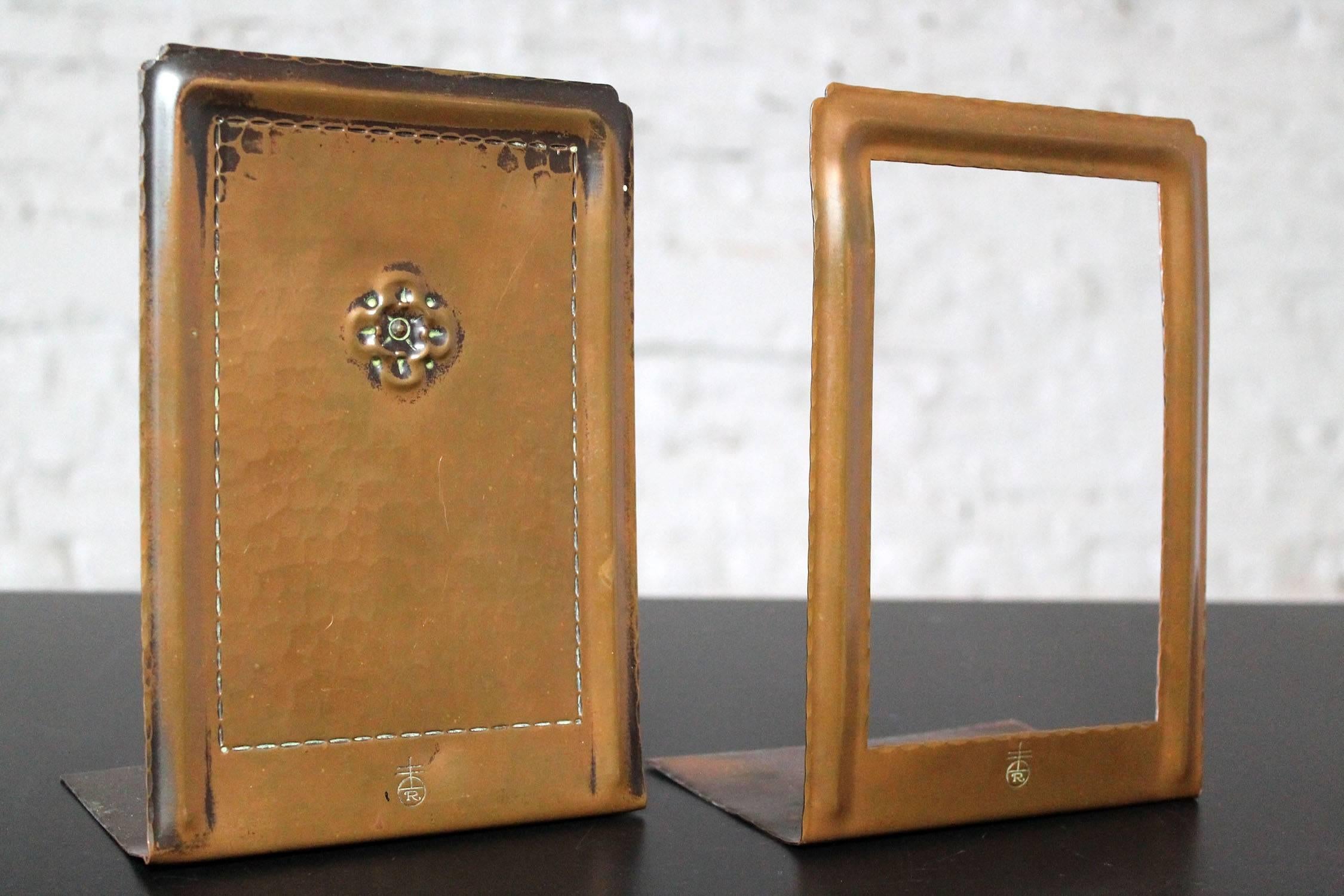 Fabulous pair of Arts and Crafts hand-hammered bookends by Roycroft in wonderful condition.

Very nice pair of Arts and Crafts bookends of hammered copper by Roycroft. This handsome pair consists of rectangular panels in copper with a bronze