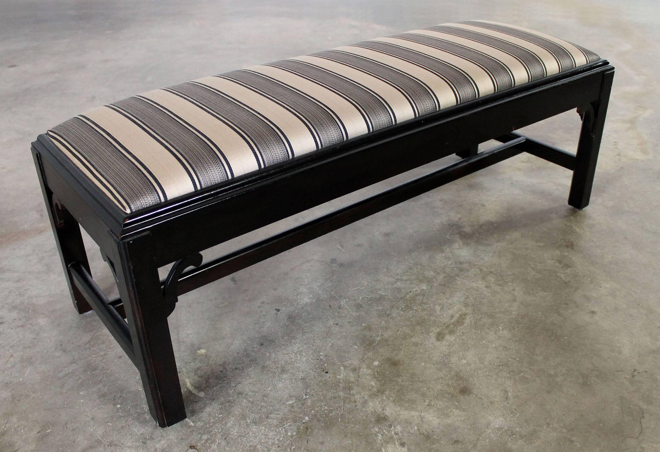 Sassy vintage Chinese Chippendale-style bench with a distressed black painted finish and new black and gold stripe upholstery. Small-scale and perfect for so many places.

Sometimes you just need a little bench. No pedigree. No big designer name.