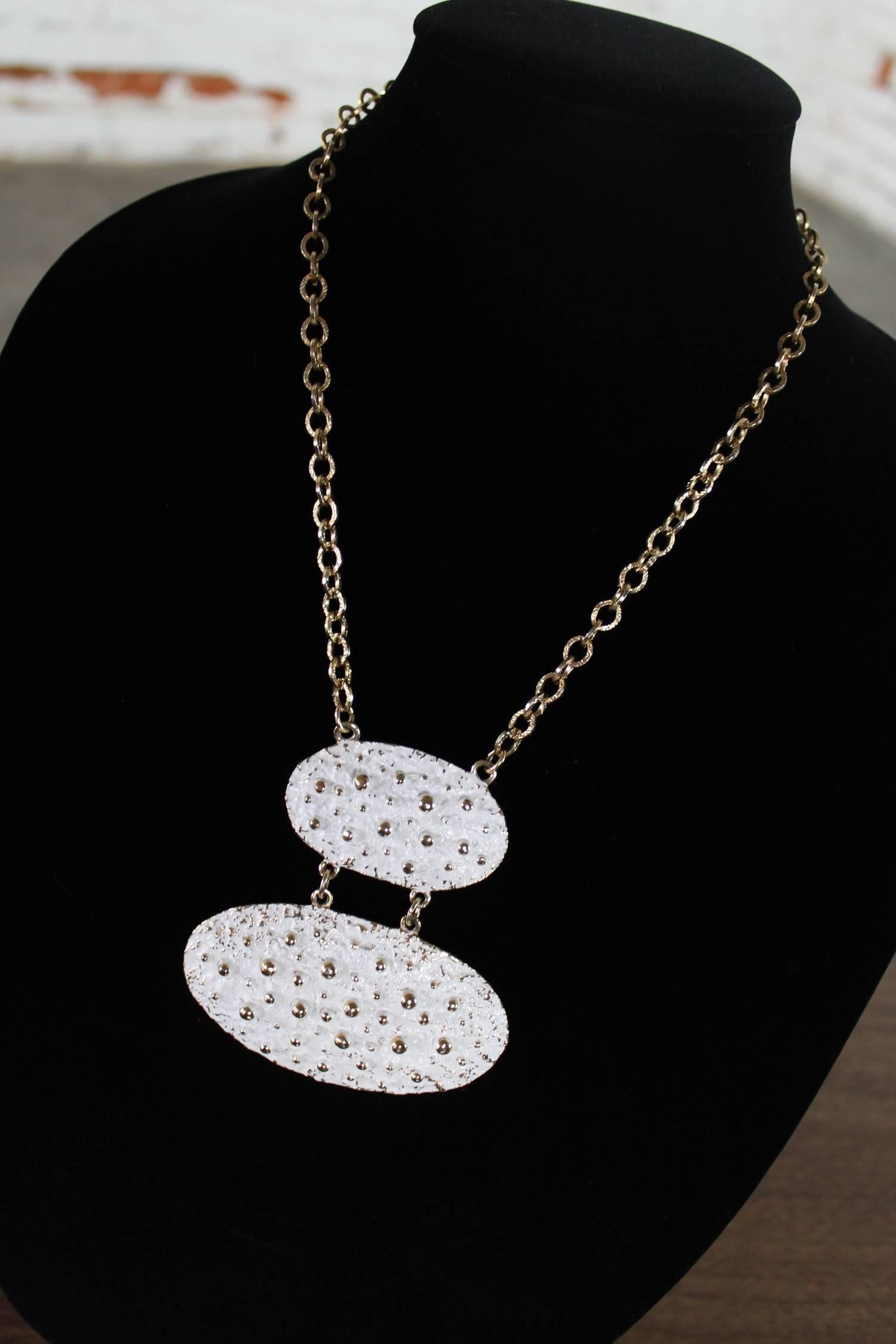 Gorgeous vintage white enamel and gold-tone Napier necklace in a chunky Brutalist, 1970s mod styling. Attributed to Francis Fujio this huge pendant necklace will make a statement whatever the outfit you wear it with.

Oh my goodness this is such a