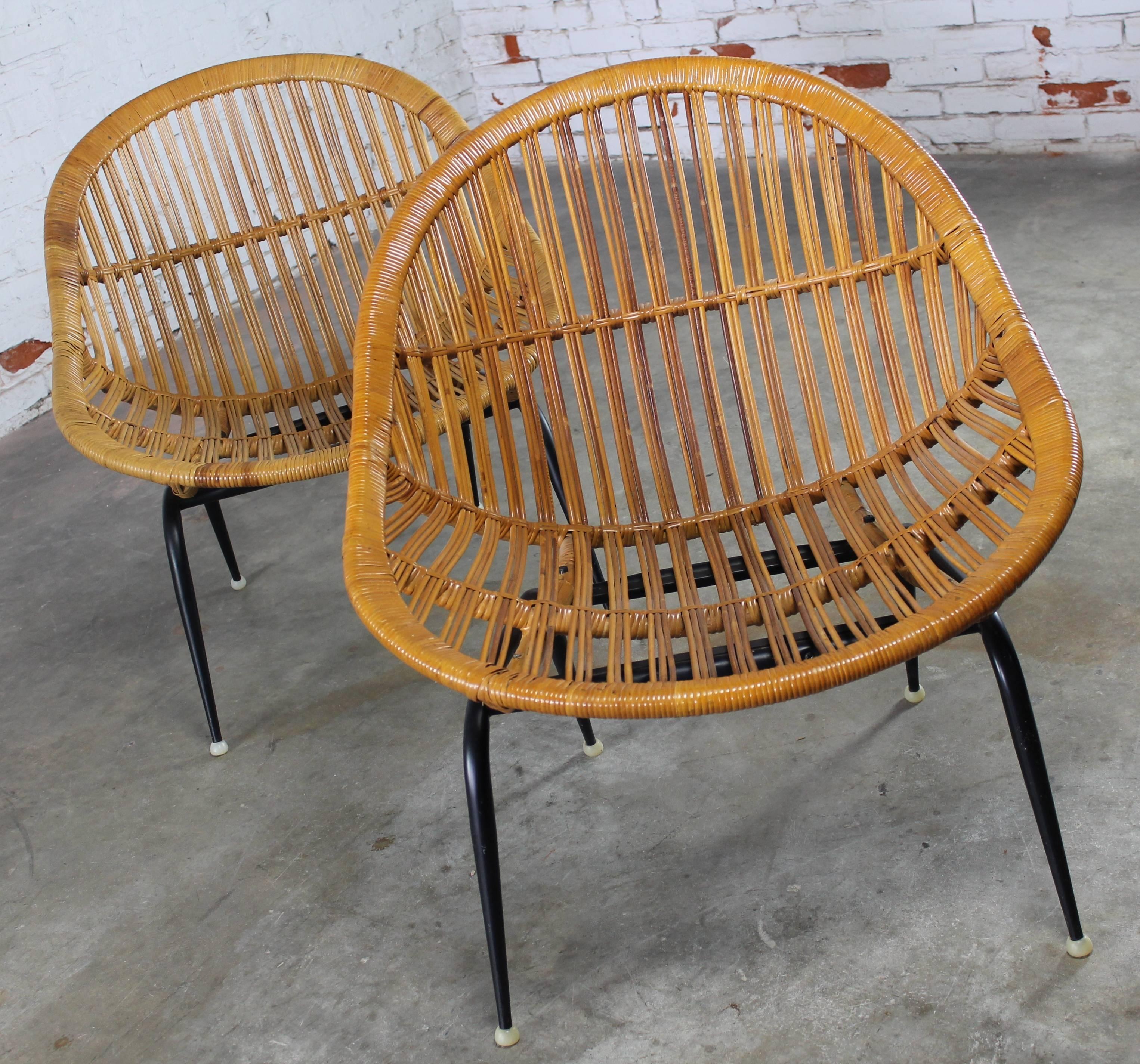 Incredible pair of Troy Sunshade Company, circa 1950 wicker rattan basket chairs. This pair is in very good condition.

What a find and particularly in such good condition! This pair of Mid-Century Modern rattan or wicker basket chairs are by the