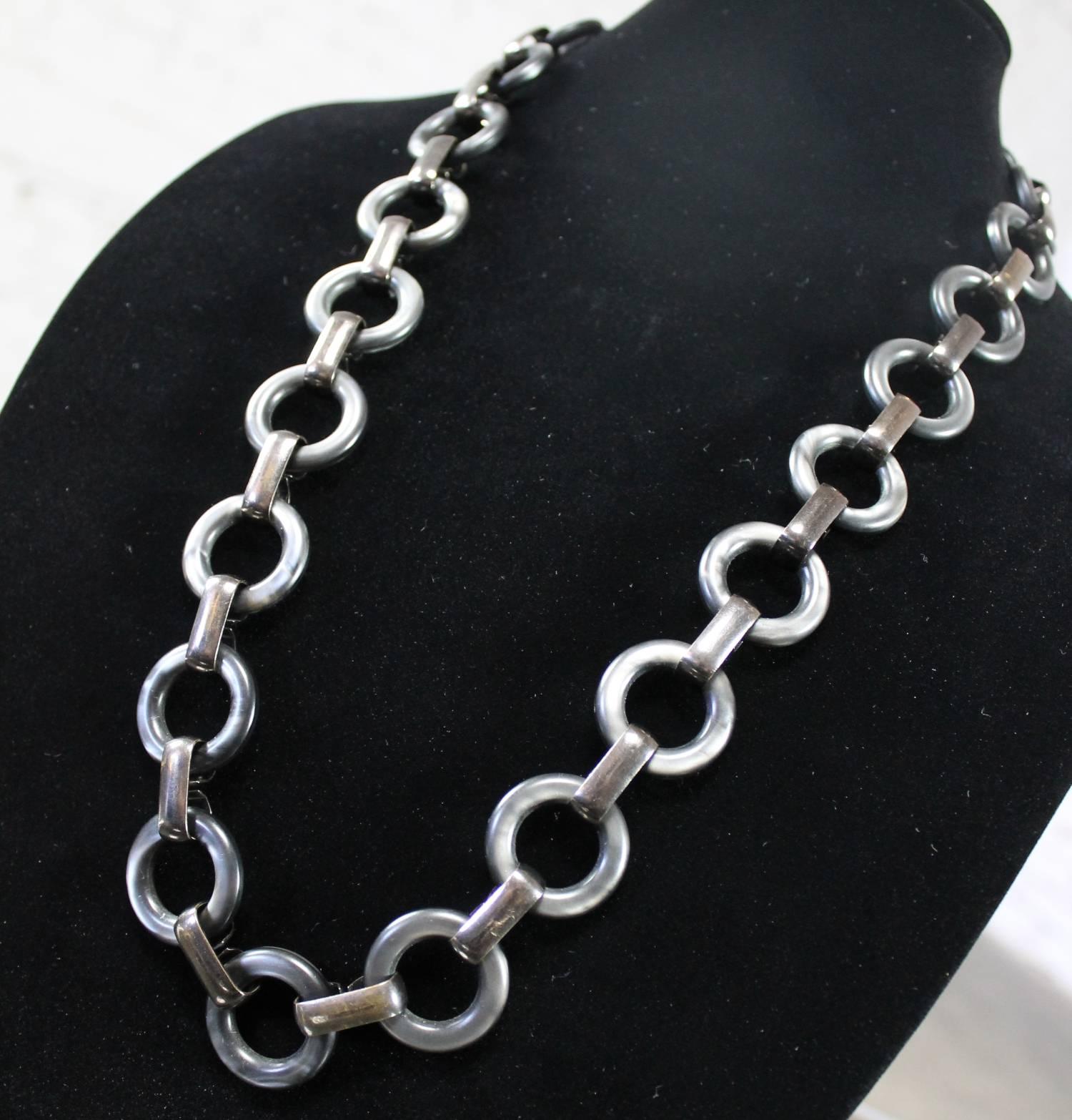 Handsome and versatile YSL (Yves Saint Laurent) chunky link necklace or belt of Lucite and metal in beautiful tones of pewter and gun-metal grey, circa 1960-1970s. This wonderful vintage piece is in like-new condition. We have found no outstanding
