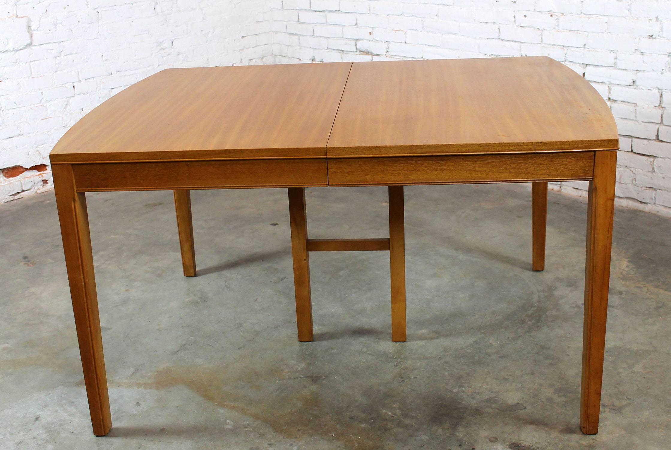 This vintage Mid-Century Modern dining table is so handsome with its bowed ends and beautiful mahogany veneer plus it is in very good age appropriate condition. The maker is undetermined but its great quality and good lines are not.

This is a