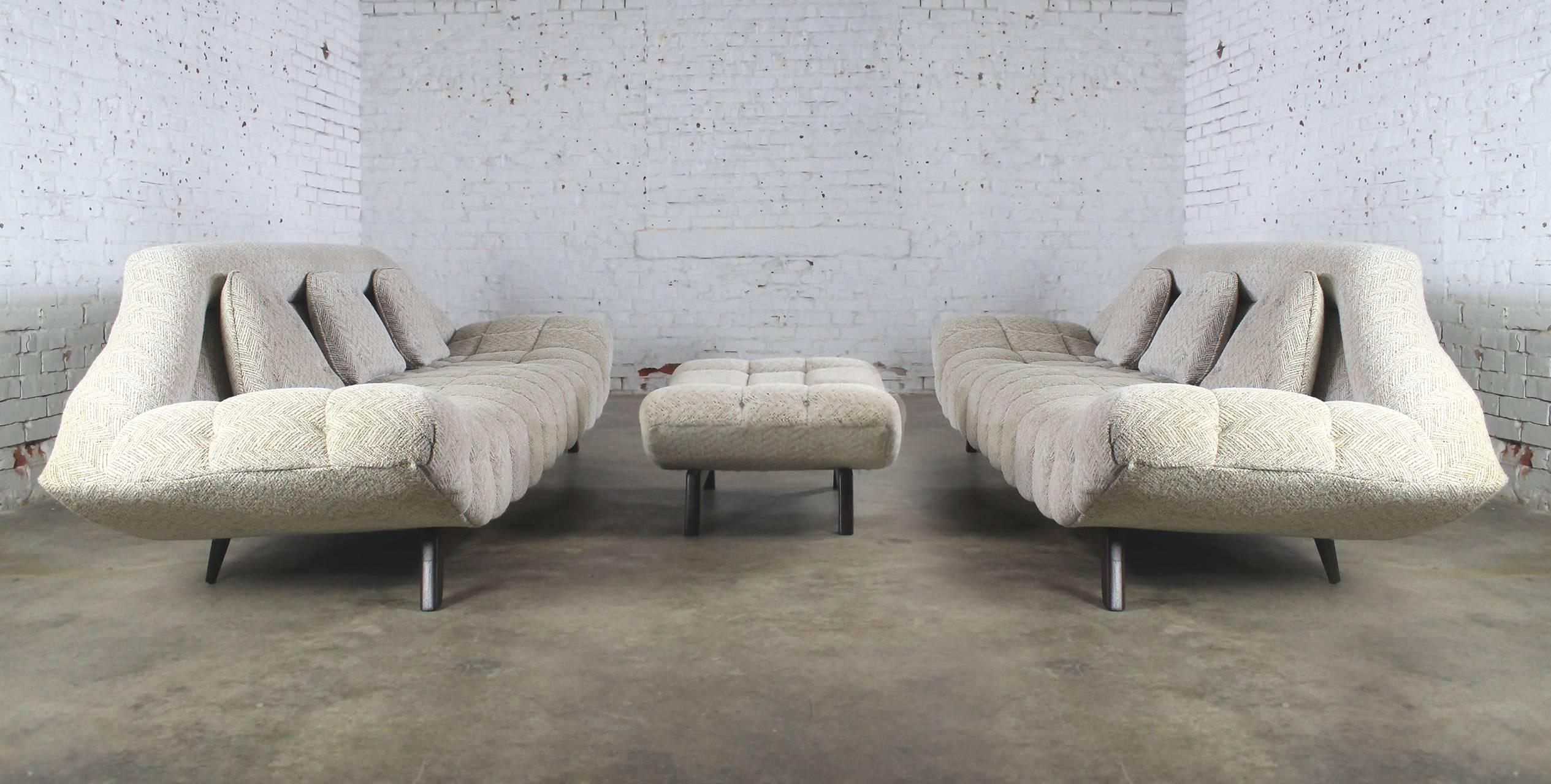 Fantastic three-piece set consisting of a pair of Adrian Pearsall style gondola sofas and matching ottoman. The epitome of Mid-Century Modern high style design, circa 1960. The set is in incredible condition.

This is one of those sets you rarely