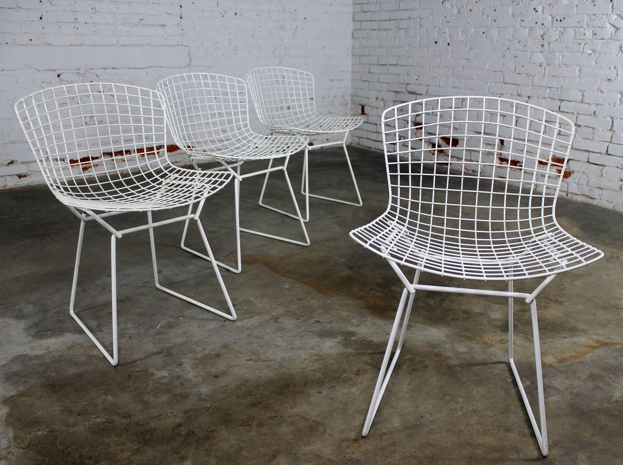 Classic Mid-Century Modern white wire Bertoia side chairs with purple seat cushions, 16 total. Buy one or all. Priced per chair. They are all in good over-all vintage condition. There is some minor chipping and rust spots to the Rilsan coating as