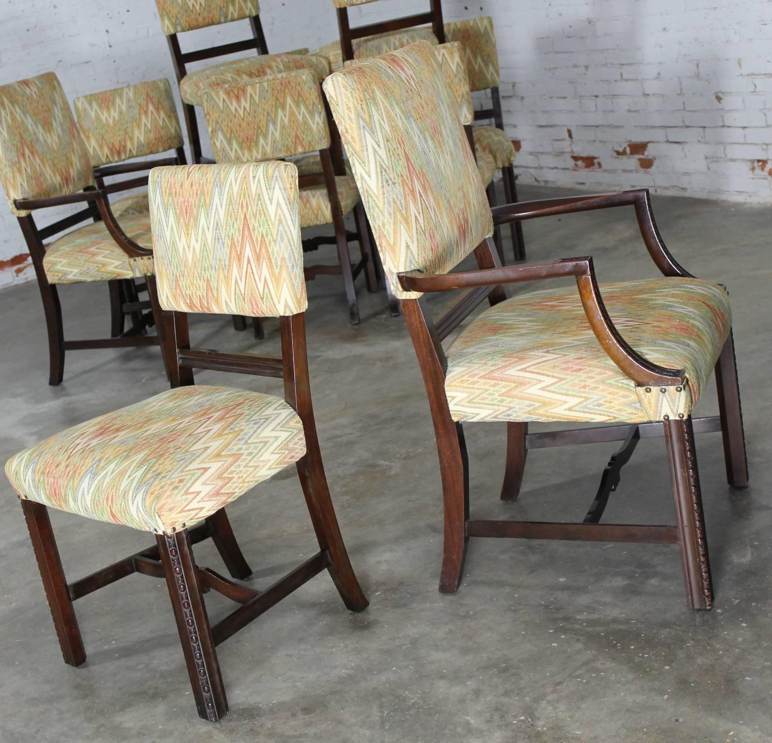 Wonderful set of ten upholstered Georgian Revival Chippendale style dining chairs. They are in great vintage condition.

This is a fabulous set of Georgian Revival Chippendale style dining chairs consisting of two-armed host and hostess chairs and