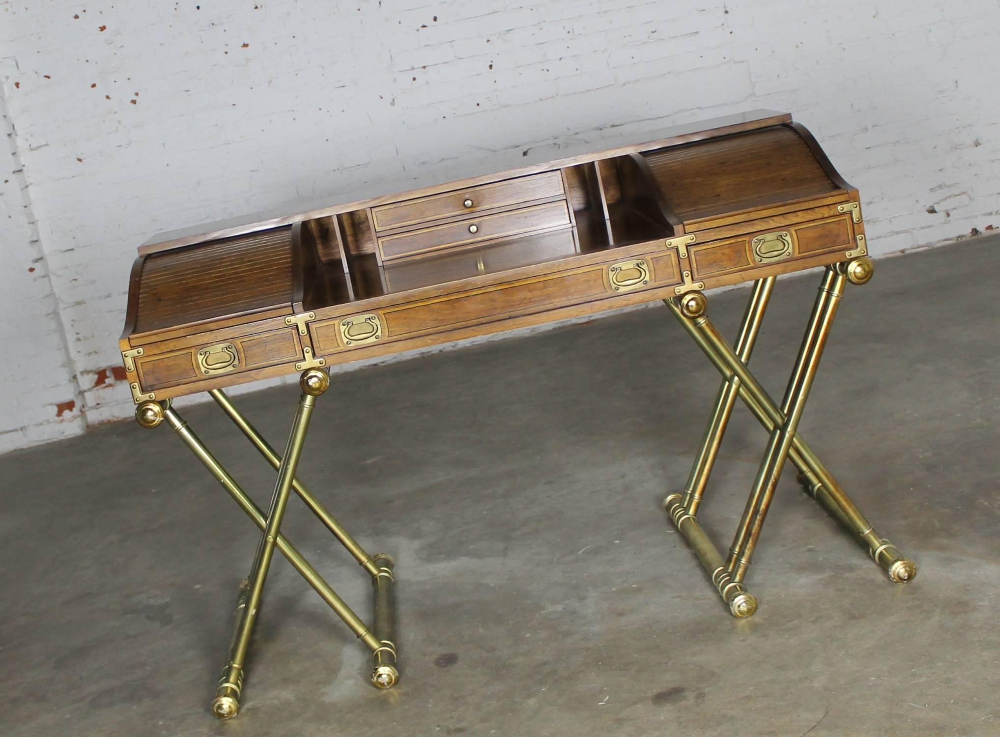Fabulous vintage Campaign style low roll top desk with gilt X-leg base by Drexel. This desk is in great vintage condition; however, there are nicks and dings as you would expect with age. Please see photos.

This is such a handsome desk by Drexel