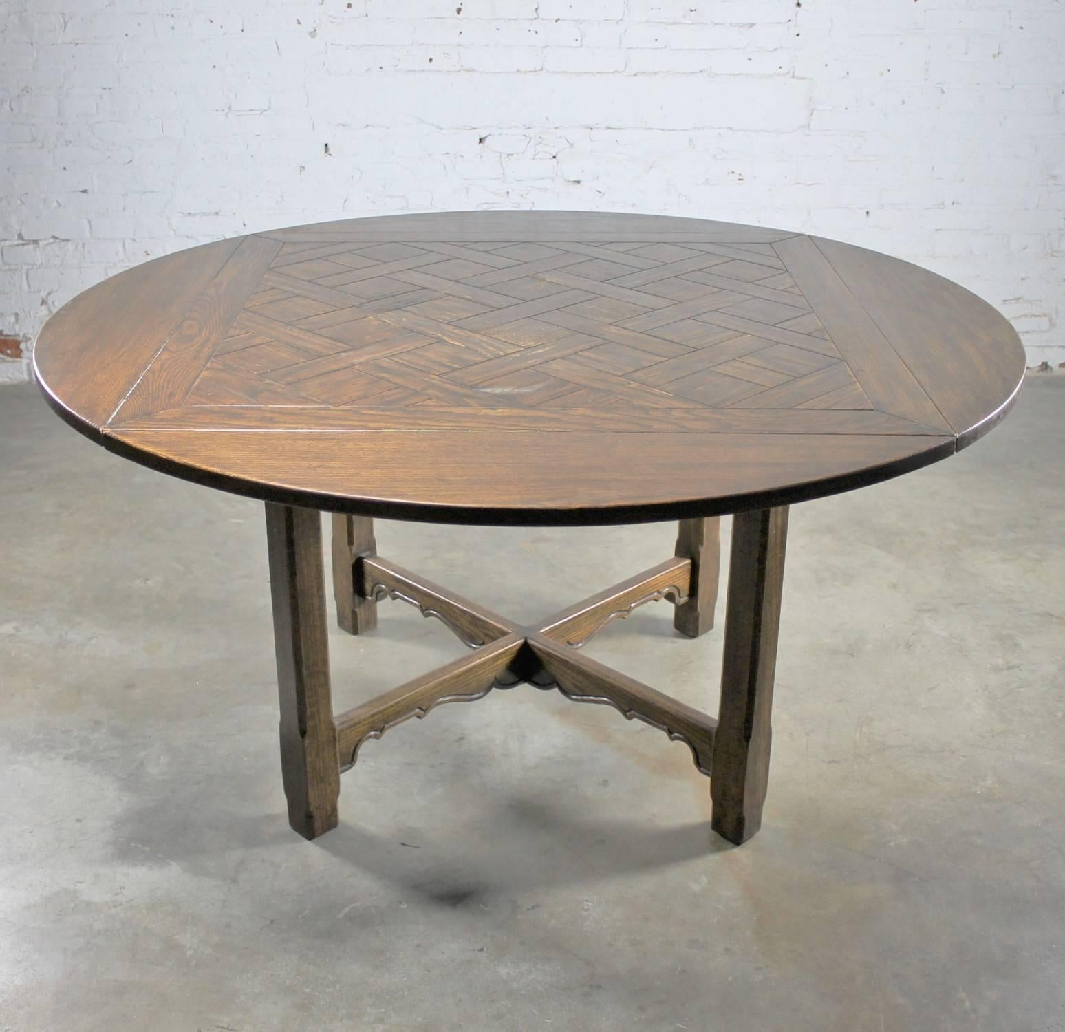 Handsome vintage oak table in the manner of an old English pub table with a square-round style parquet top. This table is naturally distressed.

What an awesome table for your wine room! Or, maybe your game room or breakfast room. Wherever you use
