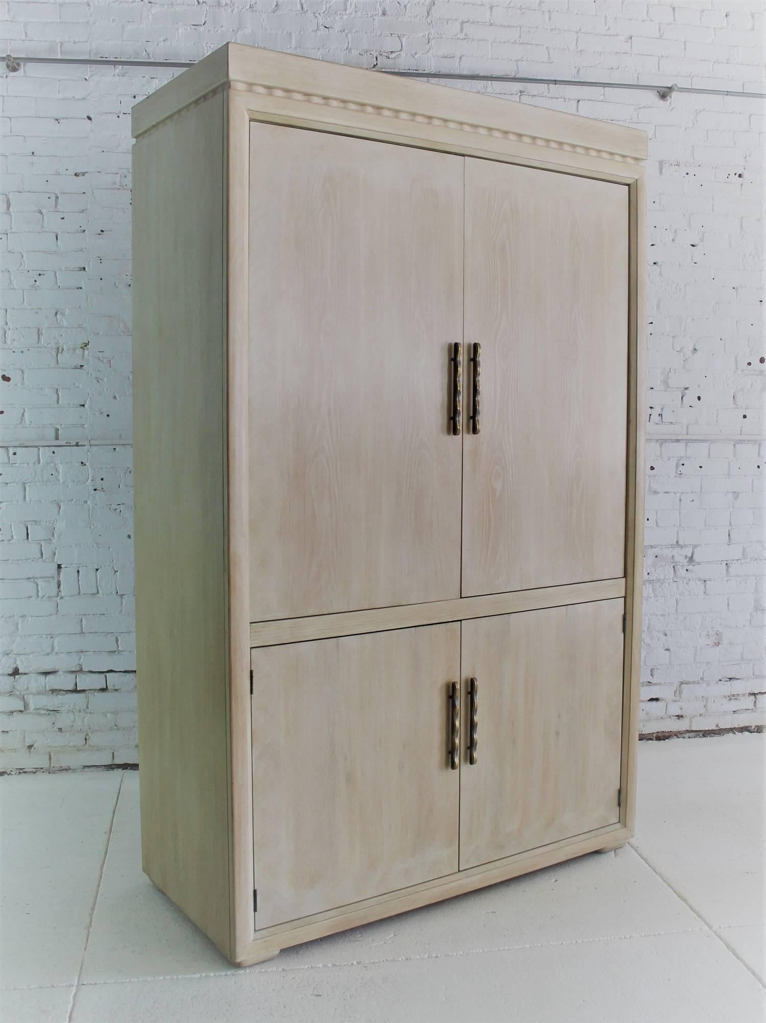 Gorgeous and monumental vintage Henredon large Brutalist-style entertainment cabinet or storage cabinet in a white-washed blonde finish. In excellent condition, circa 1993.

This handsome cabinet is a wonderful example of Henredon’s superb quality