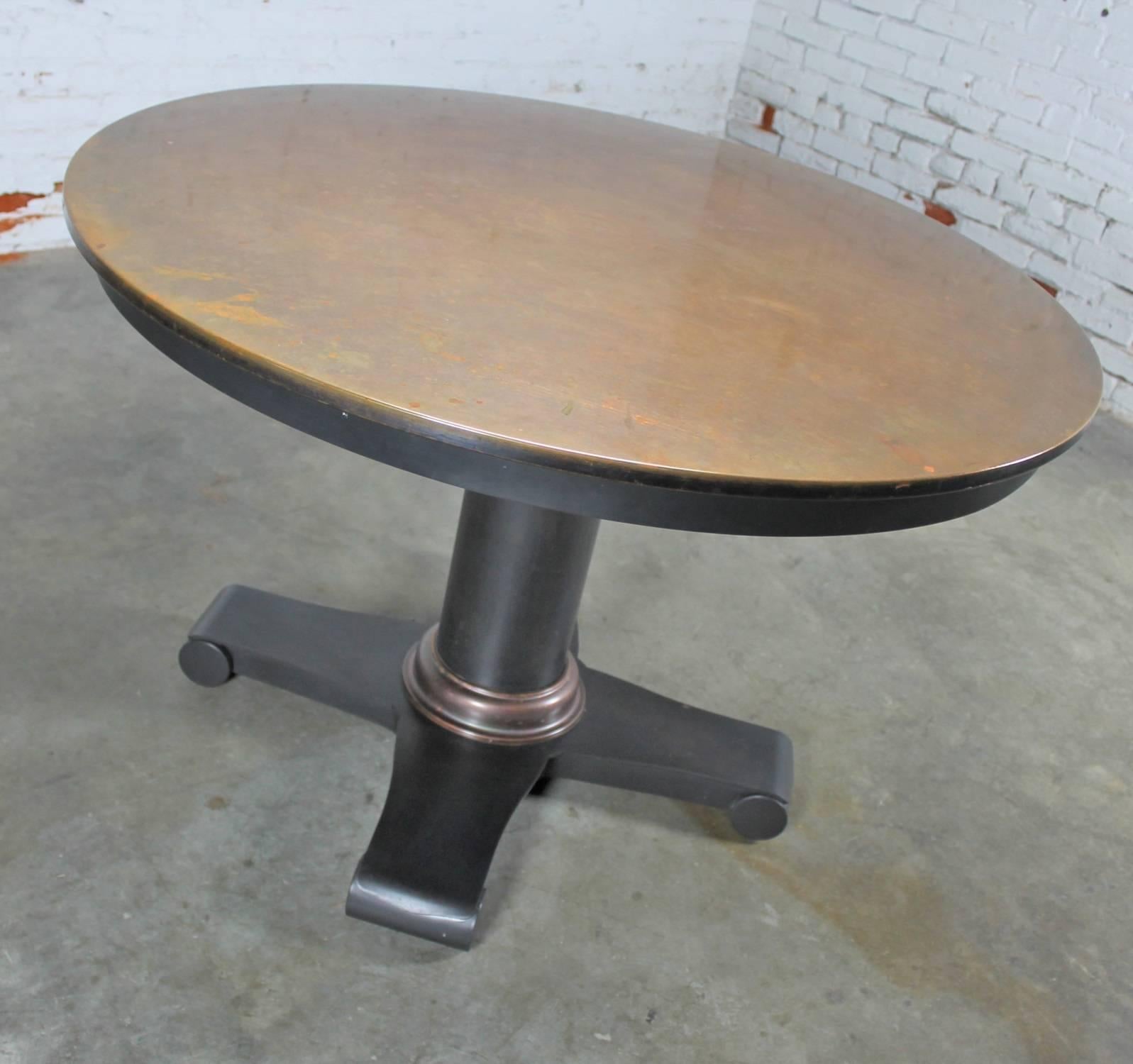 Interesting and handsome smaller round dining table or centre table with beautiful patinated copper top and steel column pedestal base. It is in great condition with lots of interesting patina, circa 2000.

This attractive copper topped round