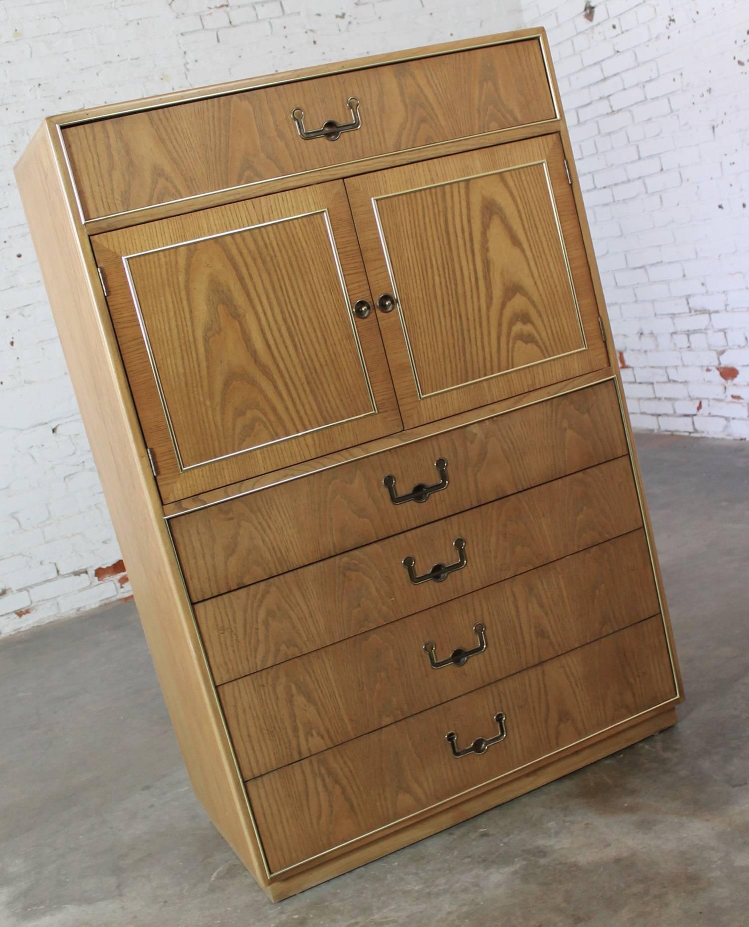 Handsome vintage Mid-Century Campaign style gentlemen’s chest by Founders Furniture done in oak with antique brass colored hardware. This piece is in wonderful vintage condition, circa 1970.

This vintage Founders Furniture company gentlemen’s chest