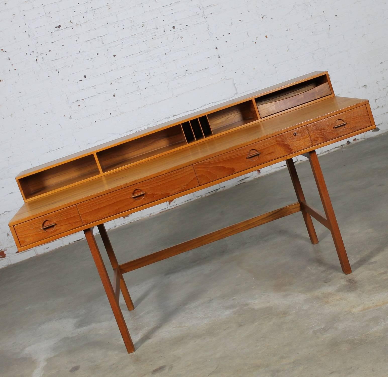 Incredible Mid-Century Danish modern teak flip-top partner’s desk attributed to Peter Løvig Nielsen and produced by Hedensted Mobelfabrik. This desk is sometimes attributed to Jens Quistgaard for Løvig. It is in wonderful vintage condition and