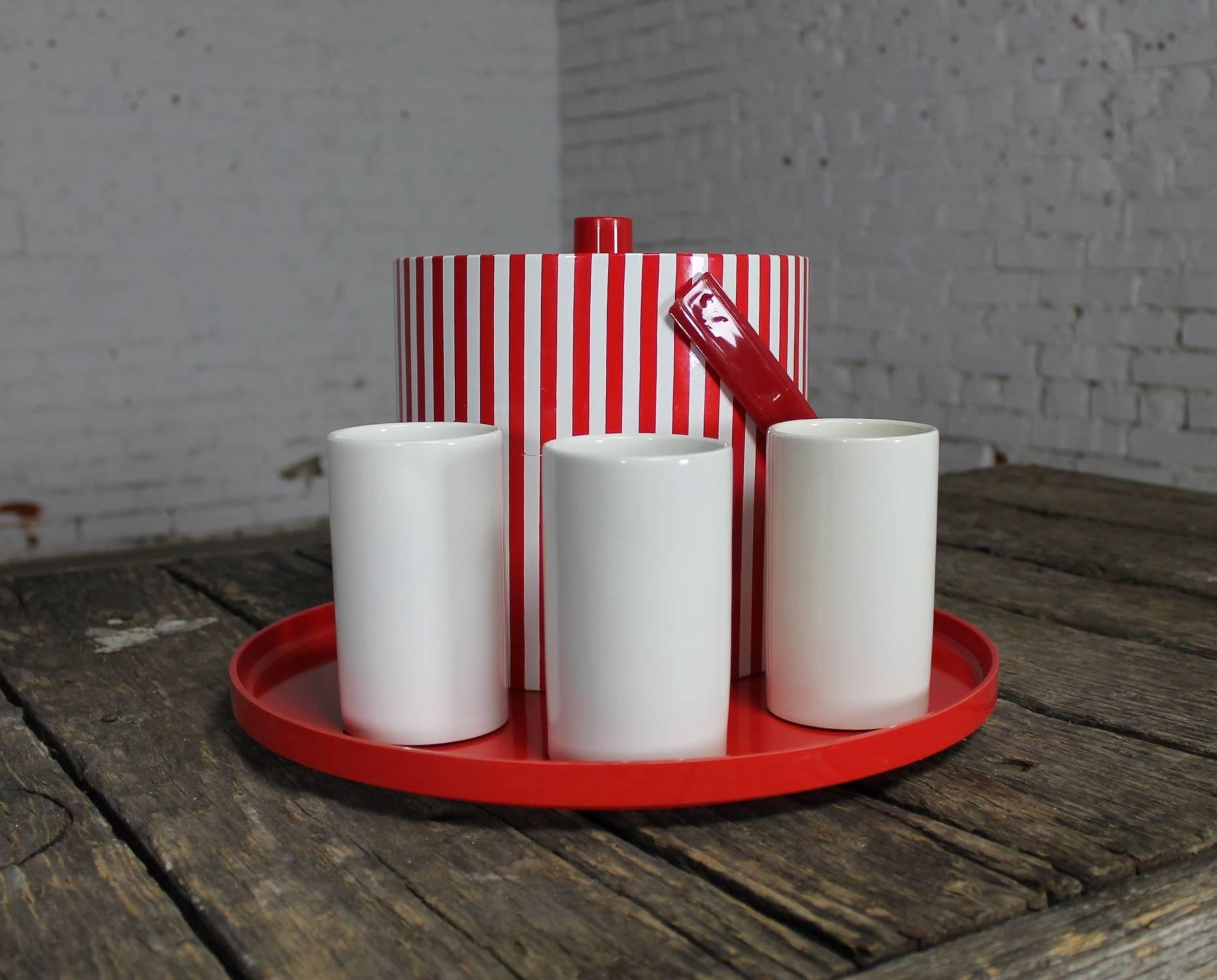 Fun vintage Mid-Century Modern style beverage set combo consisting of a Prisma red and white striped ice bucket, three white Jonathan Adler tumblers and a red Massimo Vignelli for Heller tray. All in wonderful condition.

What a fun set and just