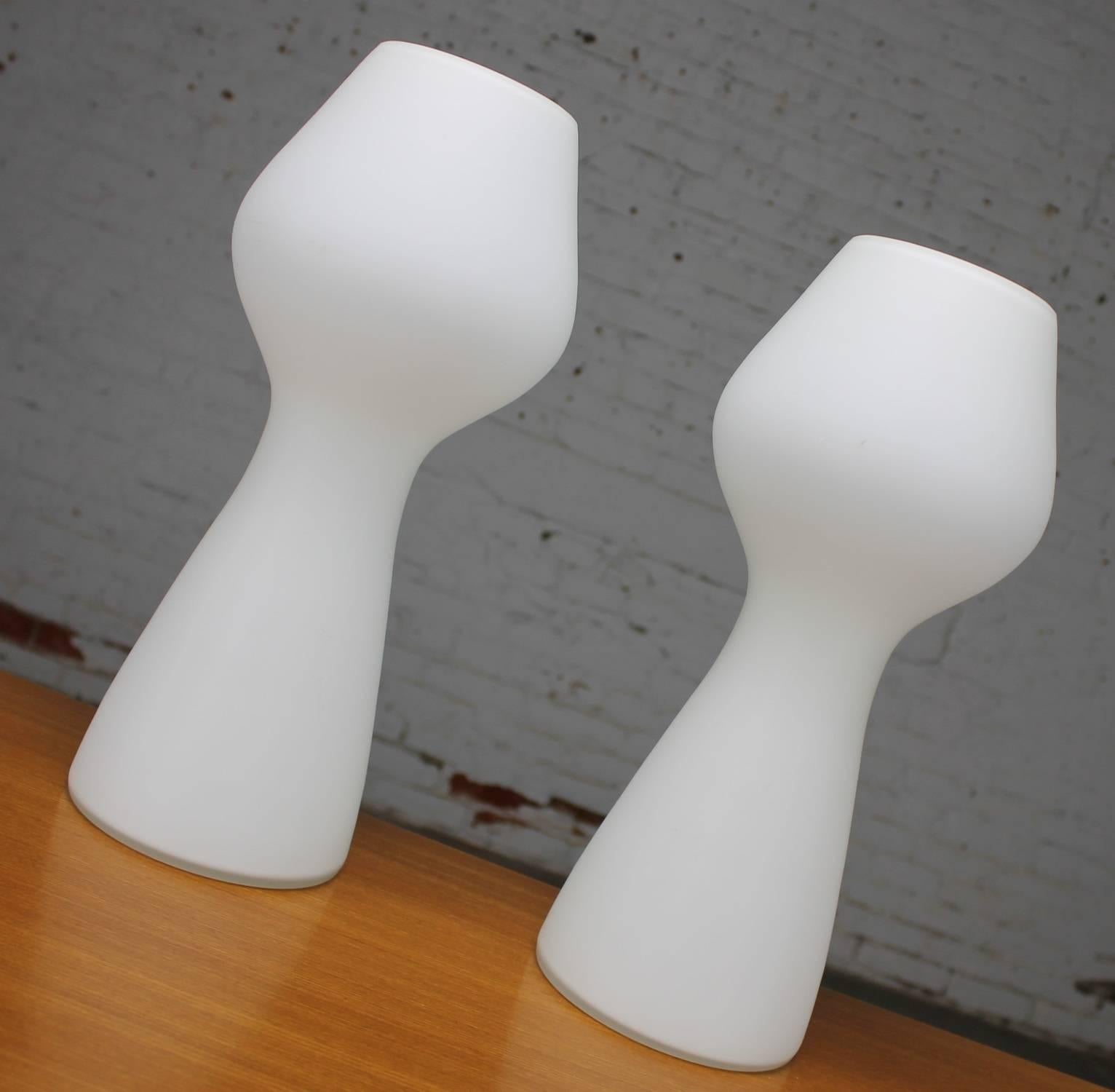Offered now are a pair of opaque white glass lamps in the style of Lisa Johansson-Pape for Finnish company Orno Stockmann made by Iittala in the shape of a bulbous mushroom. This outstanding vintage Mid-Century Modern or Scandinavian Modern pair are