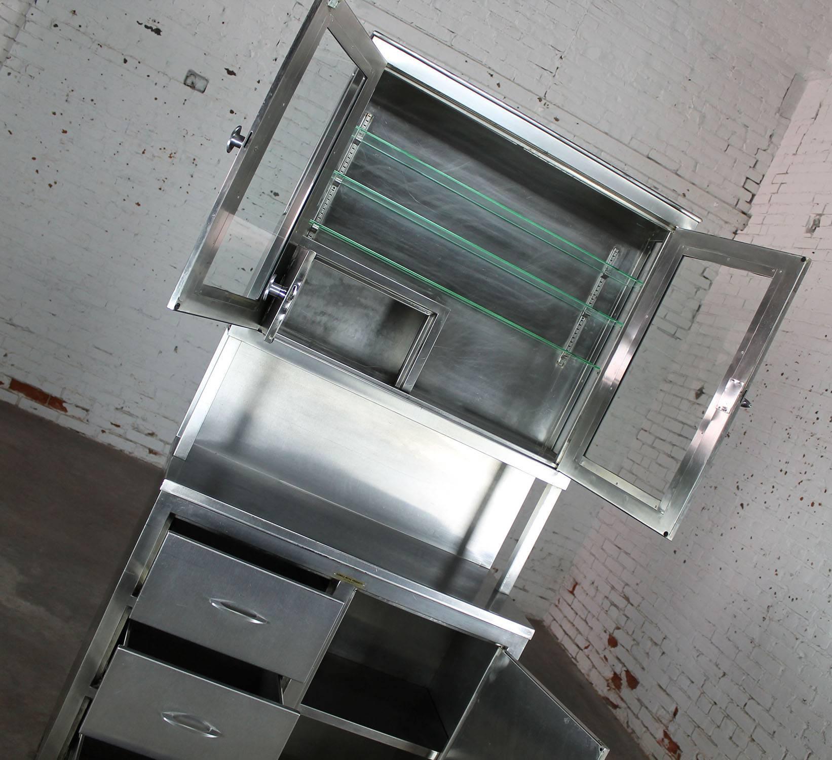 Incredible Industrial medical cupboard in stainless steel and glass. In good vintage condition.

Wow! What an awesome find for your Industrial loft kitchen or your backyard gazebo kitchen. Made in the style of an old kitchen cupboard with a solid