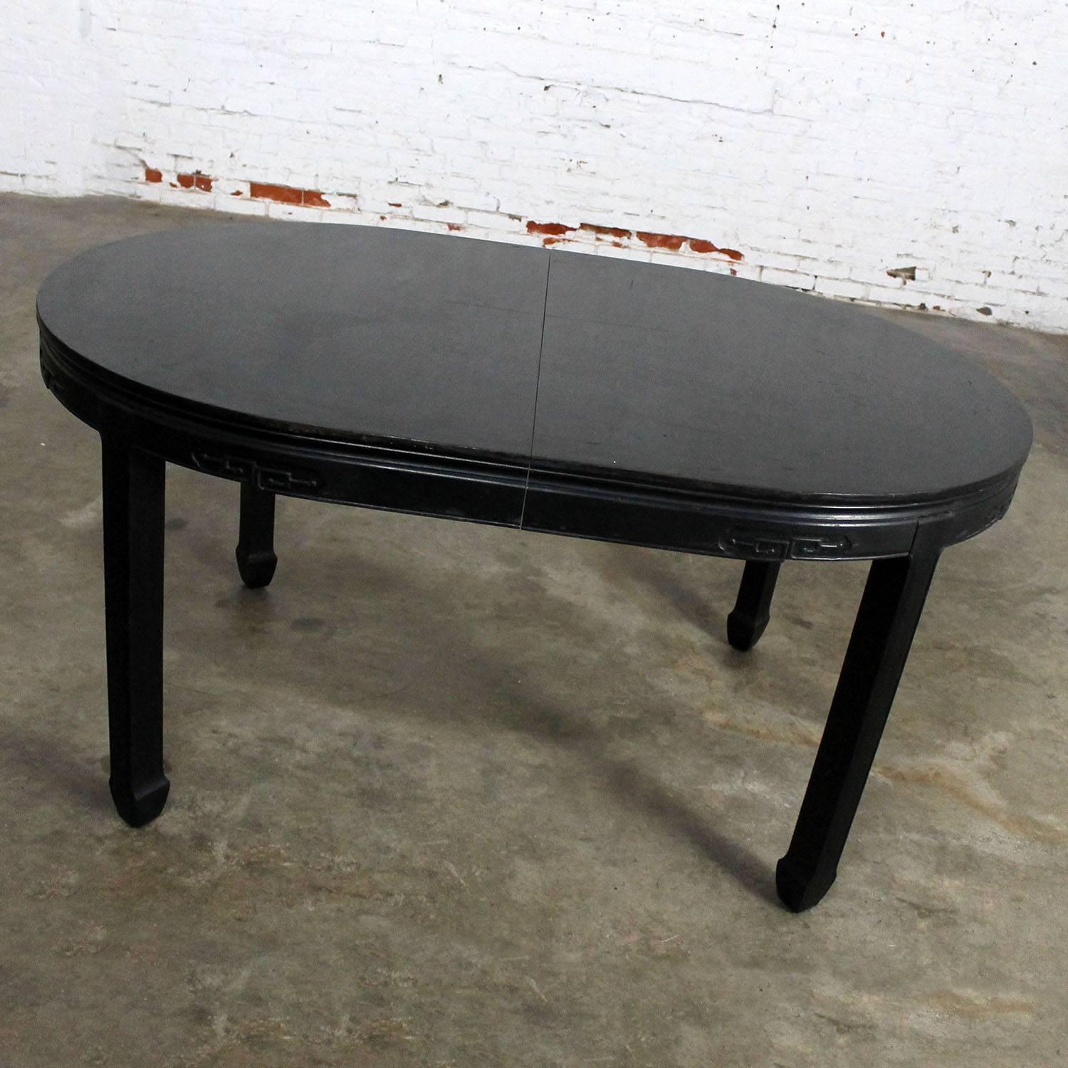 Wonderful Hollywood Regency Chin Hua style dining table attributed to Century Furniture. In a black semi-distressed finish and goes from round to oval, circa 1960.

Gorgeous Chin Hua style dining table! It has a beautiful black semi-distressed