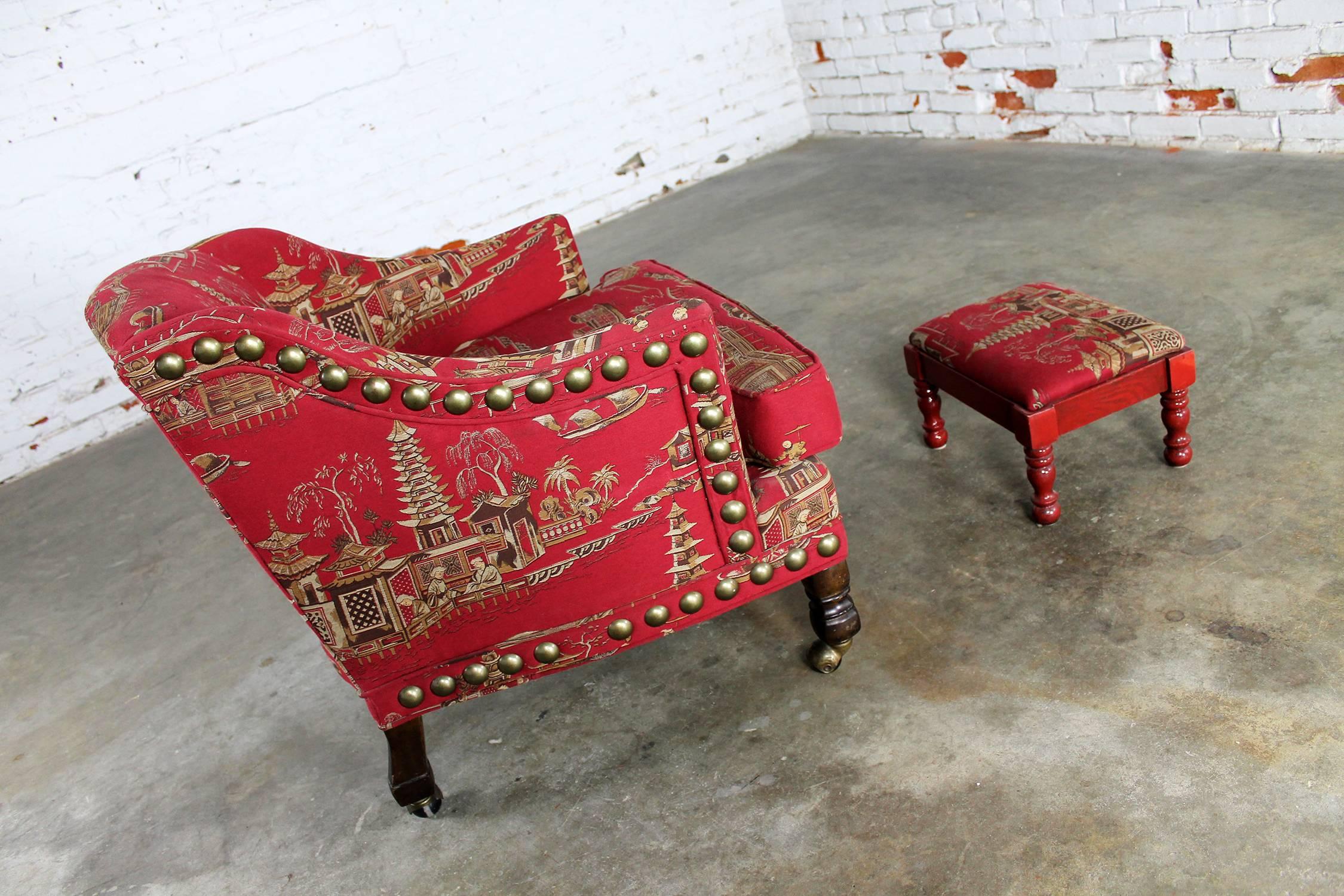 Awesome petite upholstered armchair with matching cricket style footstool. Done in a red Chinoiserie woven fabric with extra-large antique brass nailhead detail in fabulous vintage condition.

This is the most wonderful little armchair and