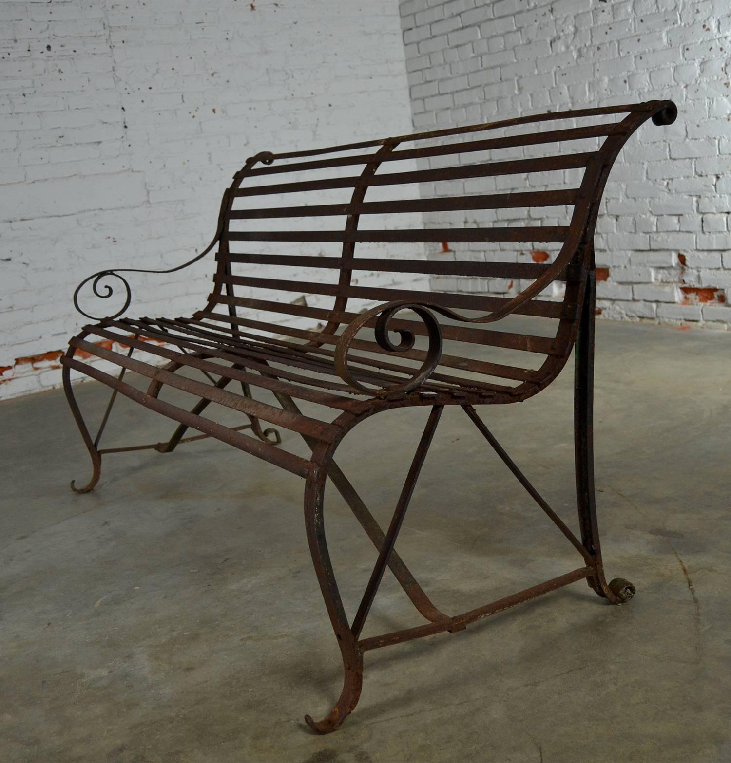Incredible antique 19th century forged strap iron and slatted garden bench. It has loads of wonderful rusty iron patina and lots of charm.

This garden bench just oozes charm. It will transform any yard, porch or gazebo into a retreat full of
