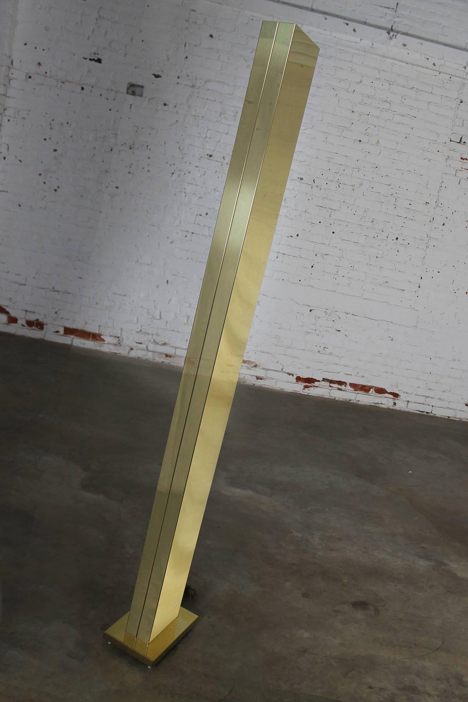 Outstanding and dramatic torchiere floor lamp by Casella Lighting. This monolith skyscraper style lamp has a polished brass plated finish and is in wonderful vintage condition. It takes a halogen bulb with 500-watt max and has a slide dimmer on the