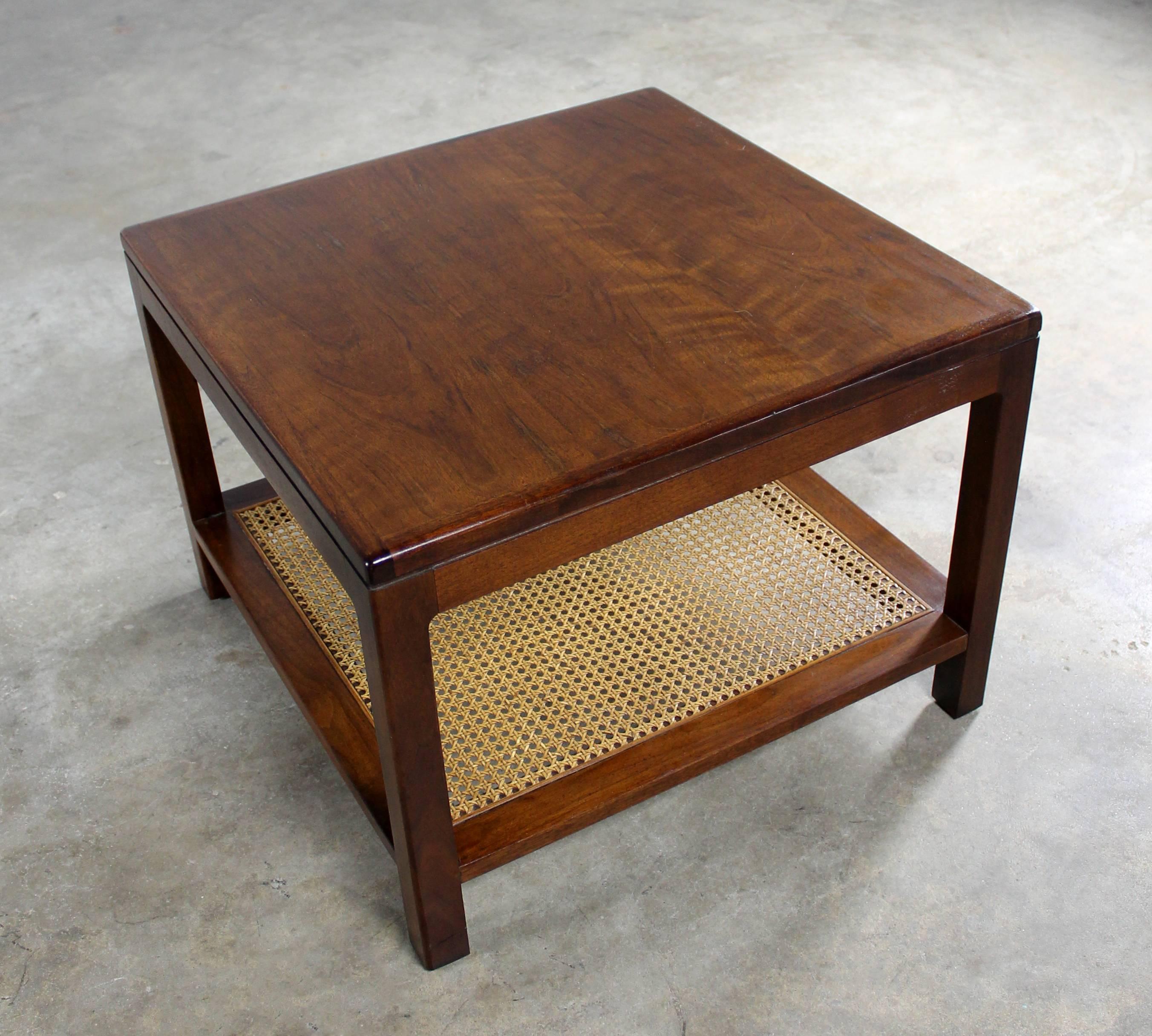 Fabulous Founders Furniture Mid-Century Modern square walnut end table with a caned lower shelf, circa 1960 and in wonderful vintage condition.

Sometimes you just need a small but mighty little table. One that is petite in size and can move from