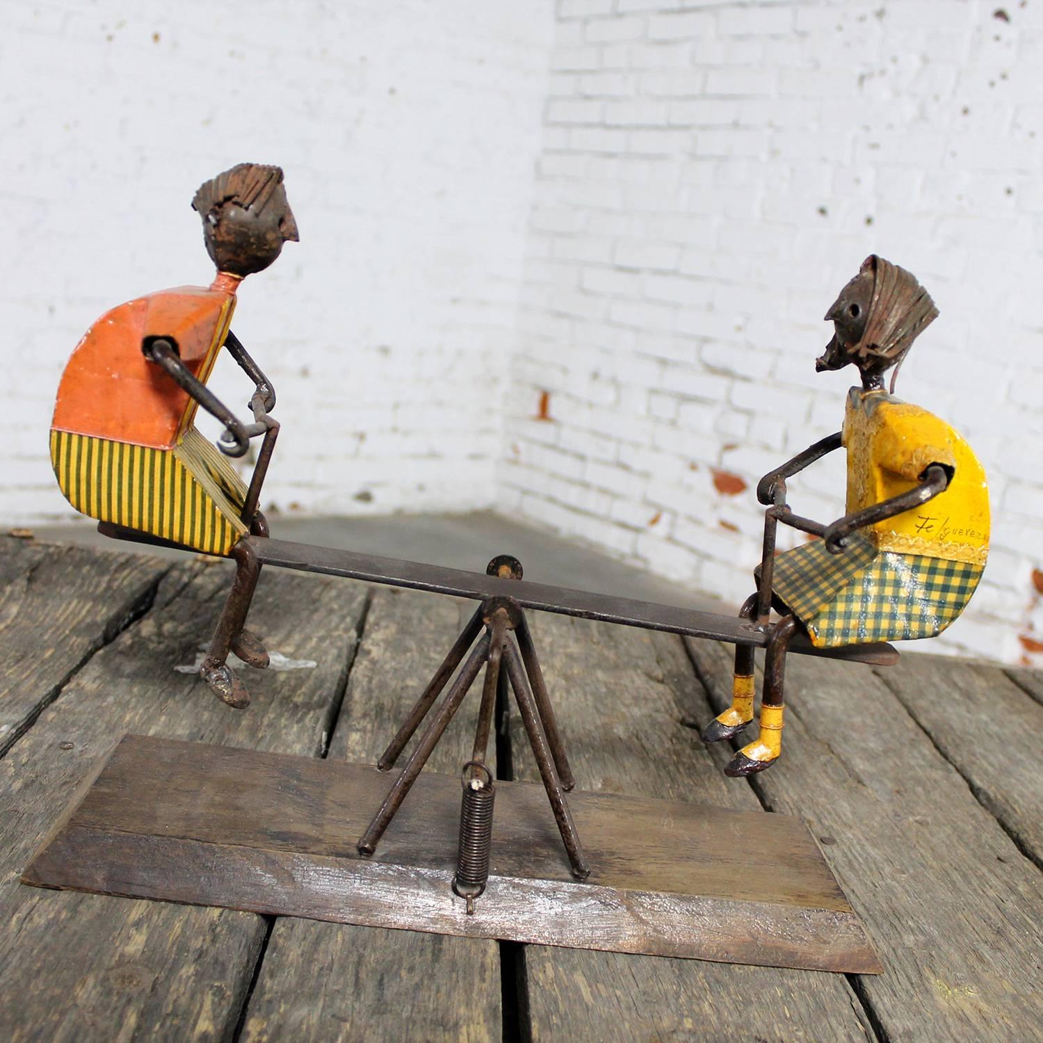 Incredible Mid-Century Modern sculpture by Manuel Felguerez depicting two children, a boy and a girl, on a see saw. Mounted on a wood base and in wonderful vintage condition, circa 1964.

This sculpture by Manuel Felguerez just makes me smile! The