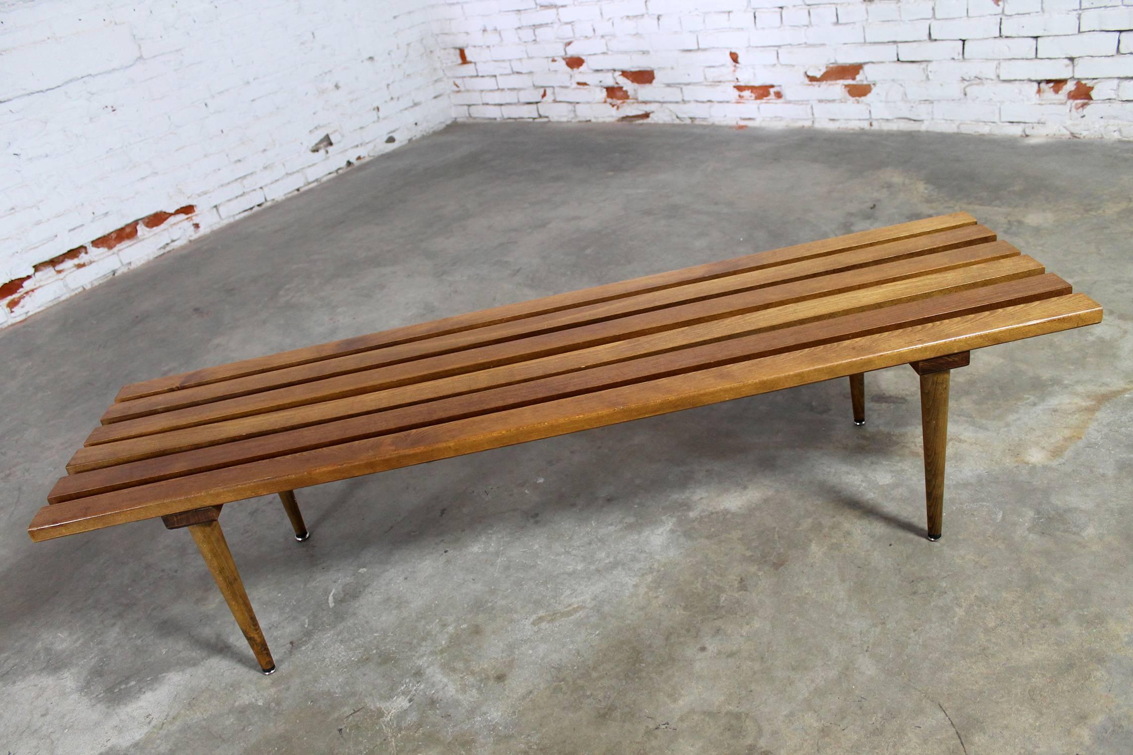 Iconic Mid-Century Modern slatted bench or coffee table from Yugoslavia. In wonderful vintage condition with the normal nicks and dings of use but nothing major. There is also a small red possibly ink mark, circa 1960s.

This fabulous slatted