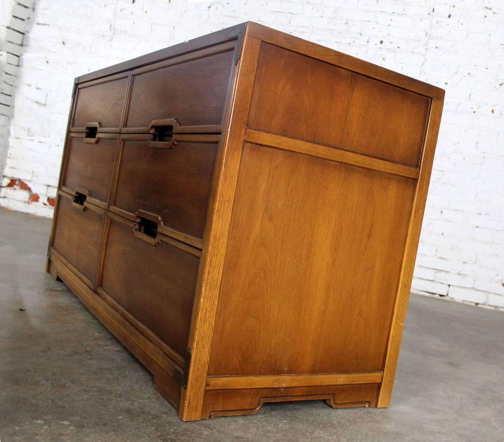 Handsome vintage Mid-Century campaign style six-drawer dresser by Drexel from their Compass Collection. In wonderful condition circa 1960s with normal nicks and dings you would expect with age.

What a great piece of furniture! Drexel has been known