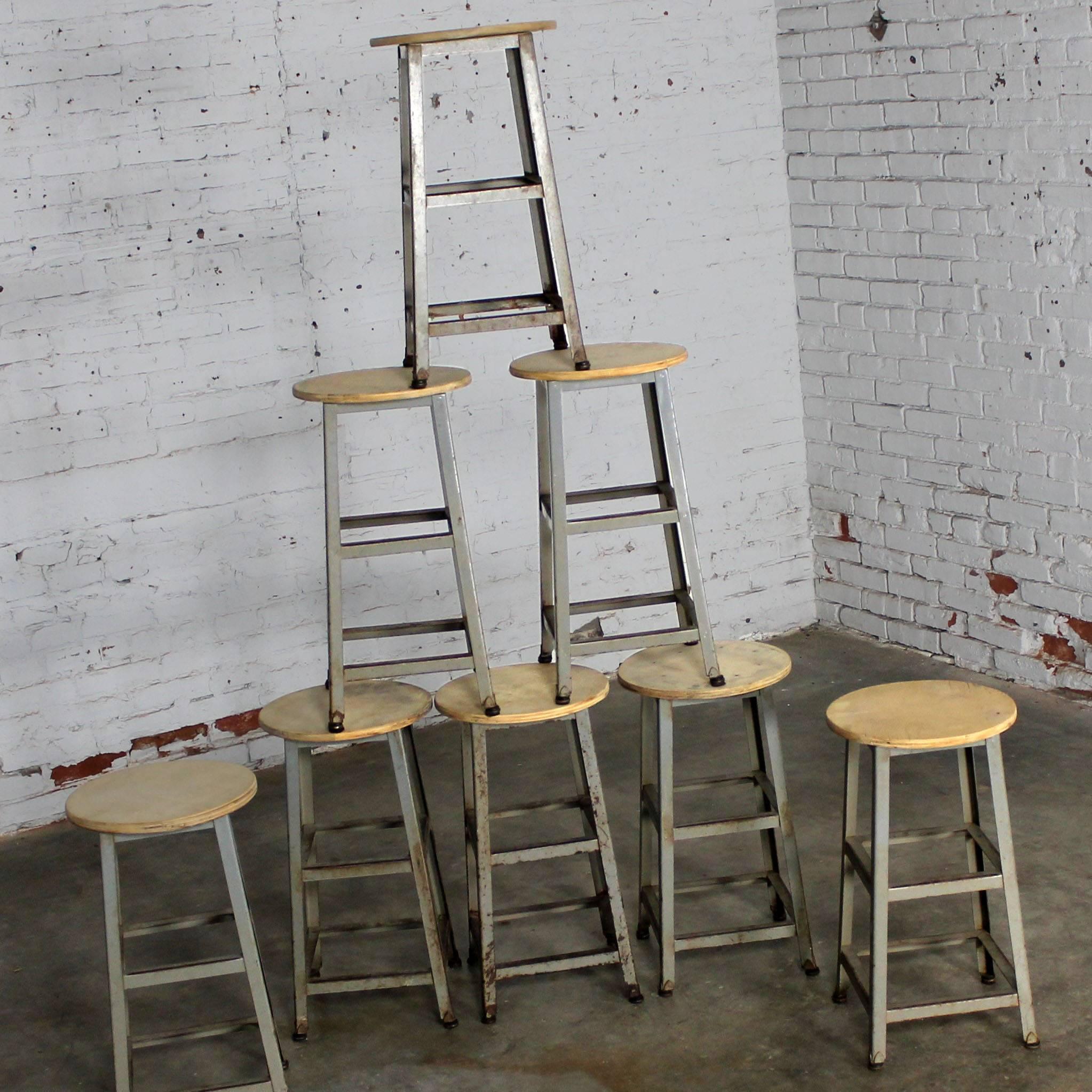 Vintage Industrial counter height steel stools with fabulous patinated finish that only comes with age. In wonderful condition. The wood tops have been sanded and are ready to be oiled, clear coated, painted or left natural to let age, circa