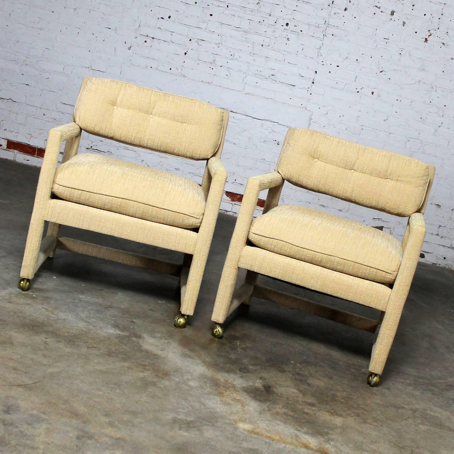 Handsome pair of circa 1970s Parsons style rolling club or armchairs in the style of Milo Baughman. This great pair are in wonderful vintage condition and ready to use. Their original tan brushed velvet type upholstery is in wonderful shape with no