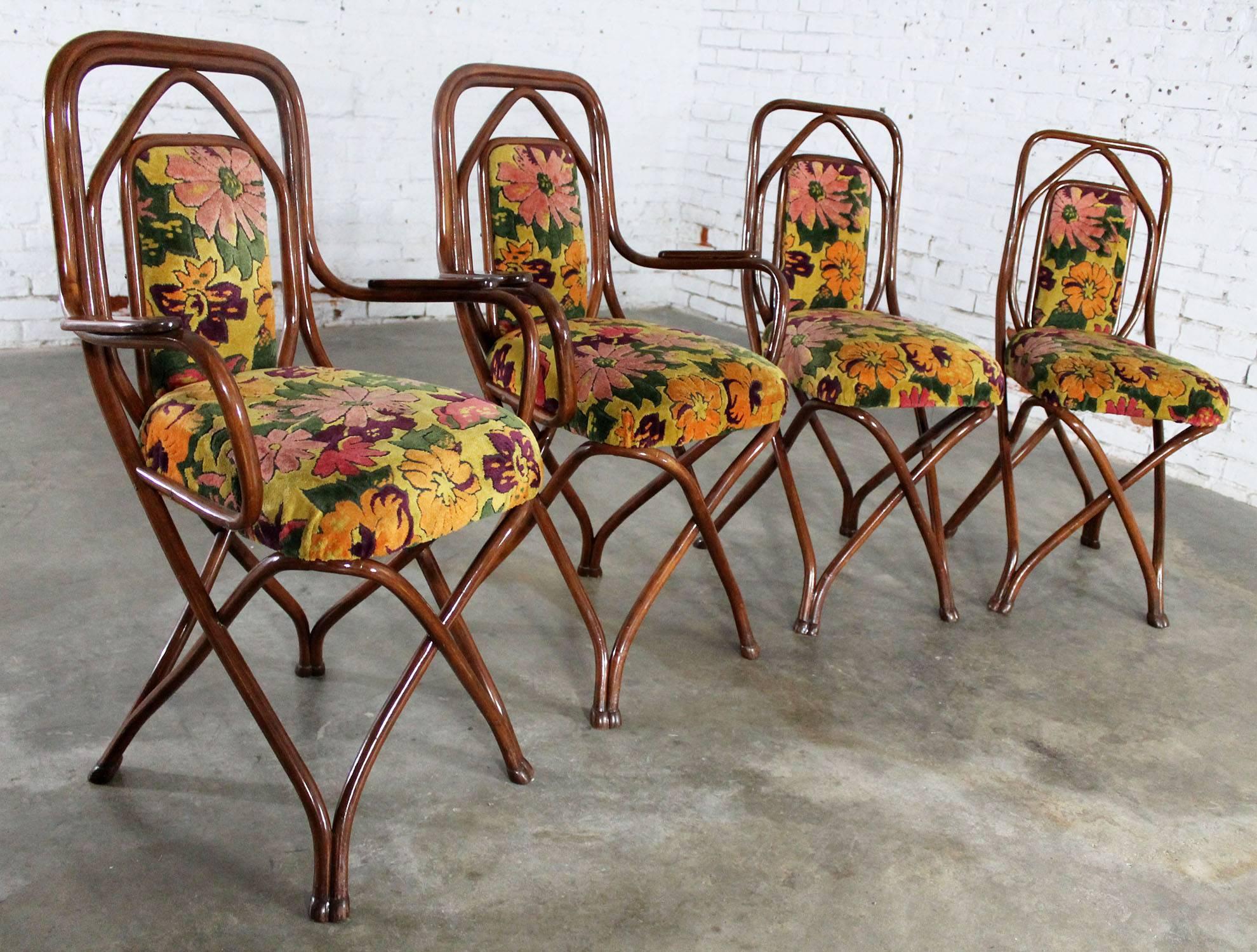 Incredible set of four circa 1850s Gebruder Thonet Bentwood dining chairs. This set consists of two arm chairs and two side chairs. They are in excellent condition and retain their circa 1950s bold and bright upholstery which gives them a