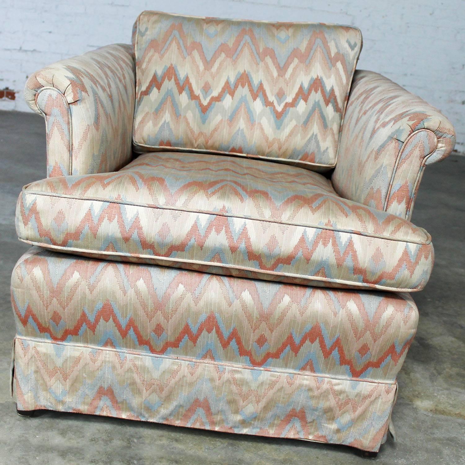 Great tuxedo style lounge chair with rolled arms and loose back and seat cushions. Upholstered in a classic flame stitch fabric. Chair and upholstery are in wonderful vintage condition and ready to use.

Blush is the new neutral and flame stitch