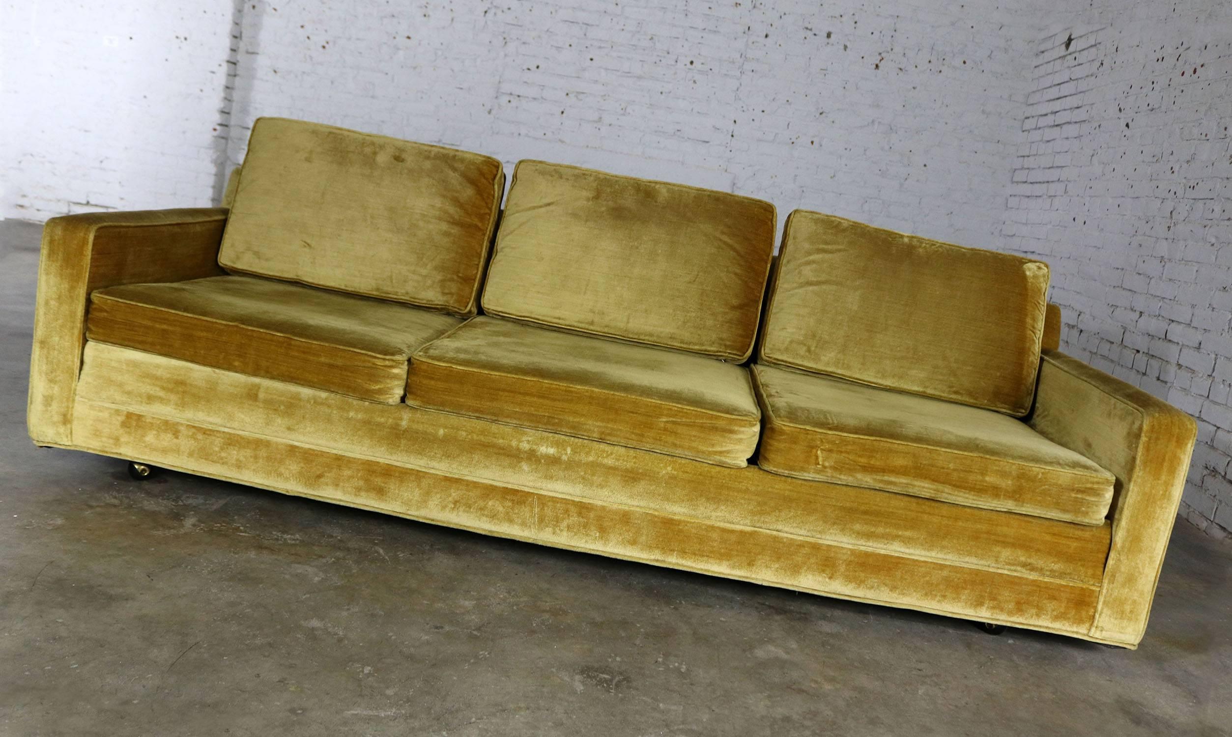 Slender and simple Lawson style three-cushion sofa in gold velvet upholstery. This vintage sofa is circa 1960s and in wonderful condition. The foam is soft in the cushions and the fabric is like-new although there is a minor wear to the bottom