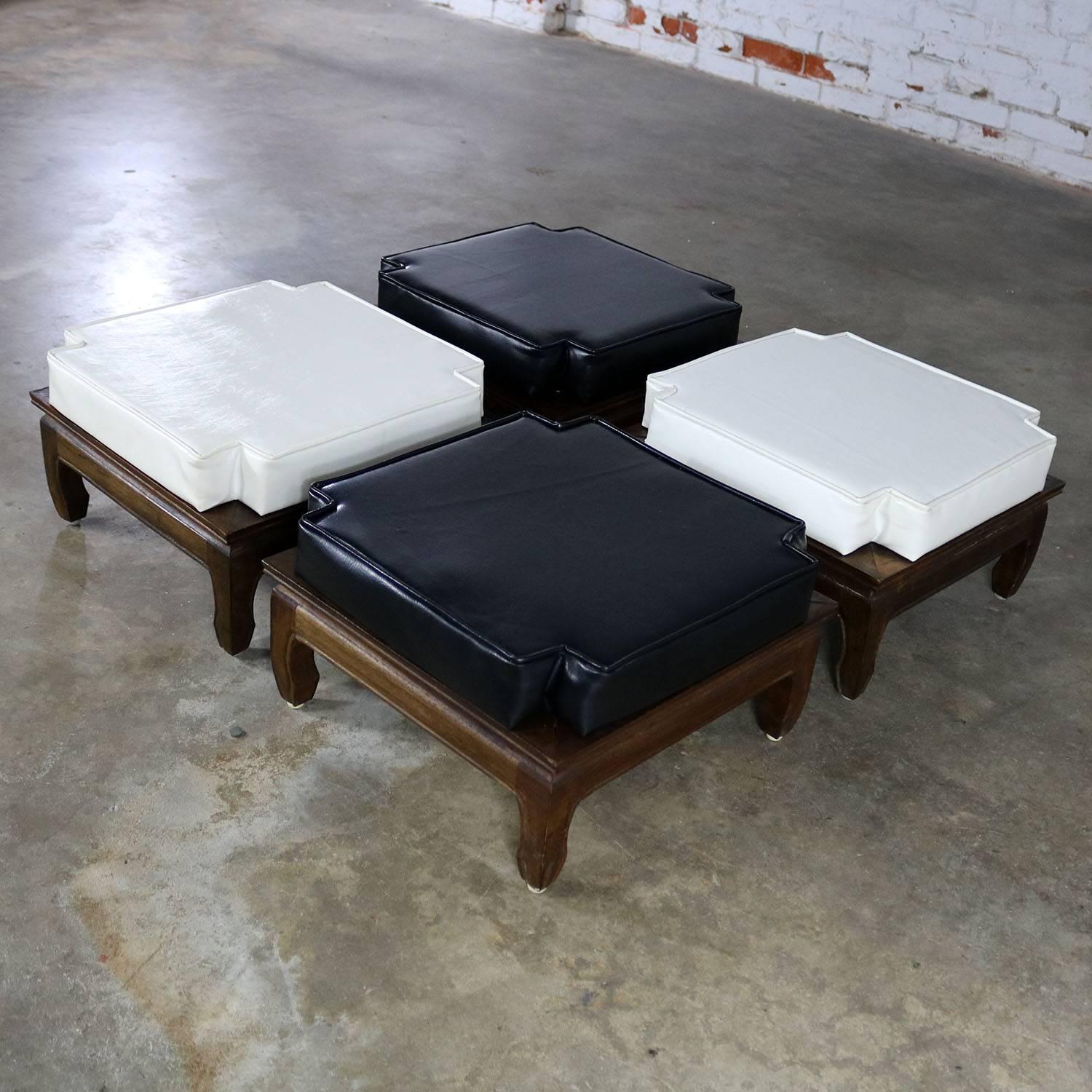 Awesome and unusual stacking ottomans with black and white upholstered cushion tops and Ming style teak base and feet. This set of four is in fabulous vintage circa mid-century original condition.

This is such a fun and handsome set of four
