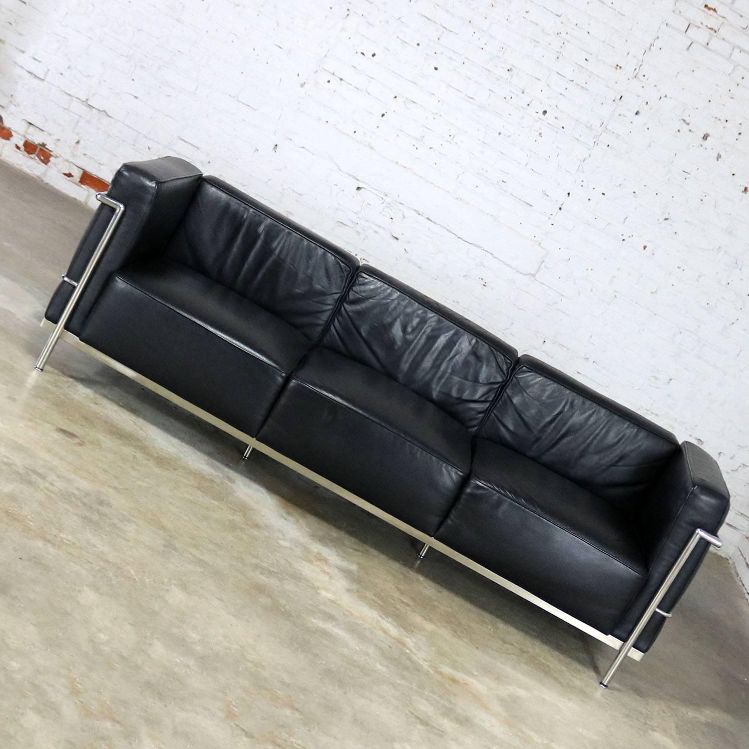 Great black leather three seat sofa in the style of Le Corbusier LC3 Grand Comfort chairs. This one produced by Alphaville Design. It is in wonderful condition and circa 2007.

Superbly done in the style of Le Corbusier’s LC3 Grand Comfort sofa