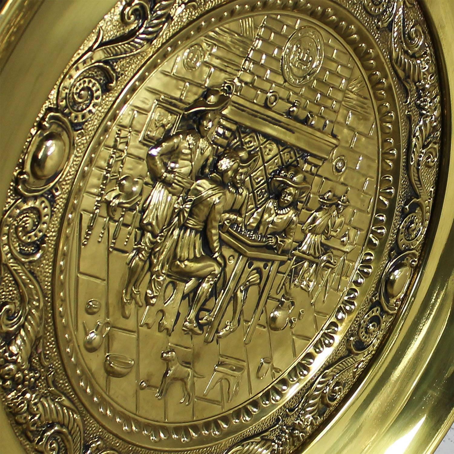 Incredible monumental, 34.5 inches in diameter, decorative brassware hanging wall plates with embossed English pub scene design. Made by Peerage Brass circa 1950s and in wonderful vintage condition.

If you are looking for large three-dimensional