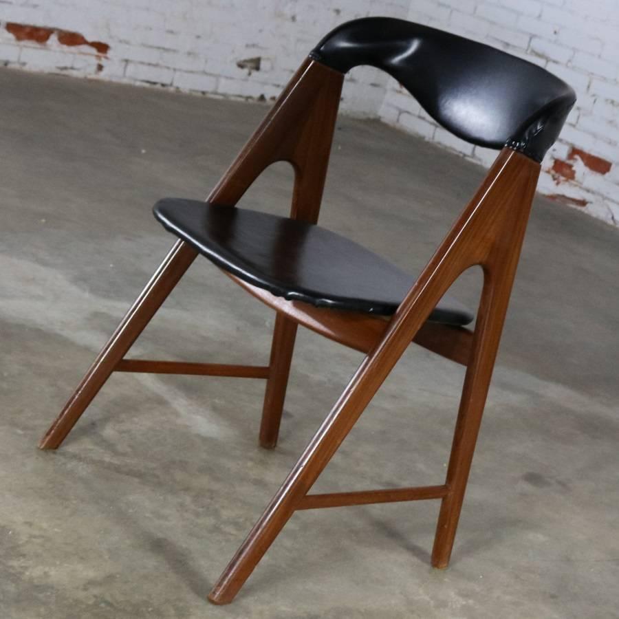 Small versatile Scandinavian or Danish Modern A frame side chair with black vinyl upholstery in the manner of the Compass chair designed by Kai Kristiansen. This chair is in wonderful vintage condition circa 1960s.

Sometimes you just need a small