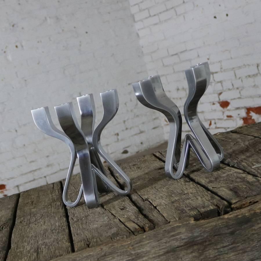 Handsome pair of die-cast zinc candelabra entitled chorus designed by Karim Rashid for Umbra. The pair are in fabulous pre-owned condition. They even have their original boxes, circa 2004.

These candelabra are simply stunning. Described by their