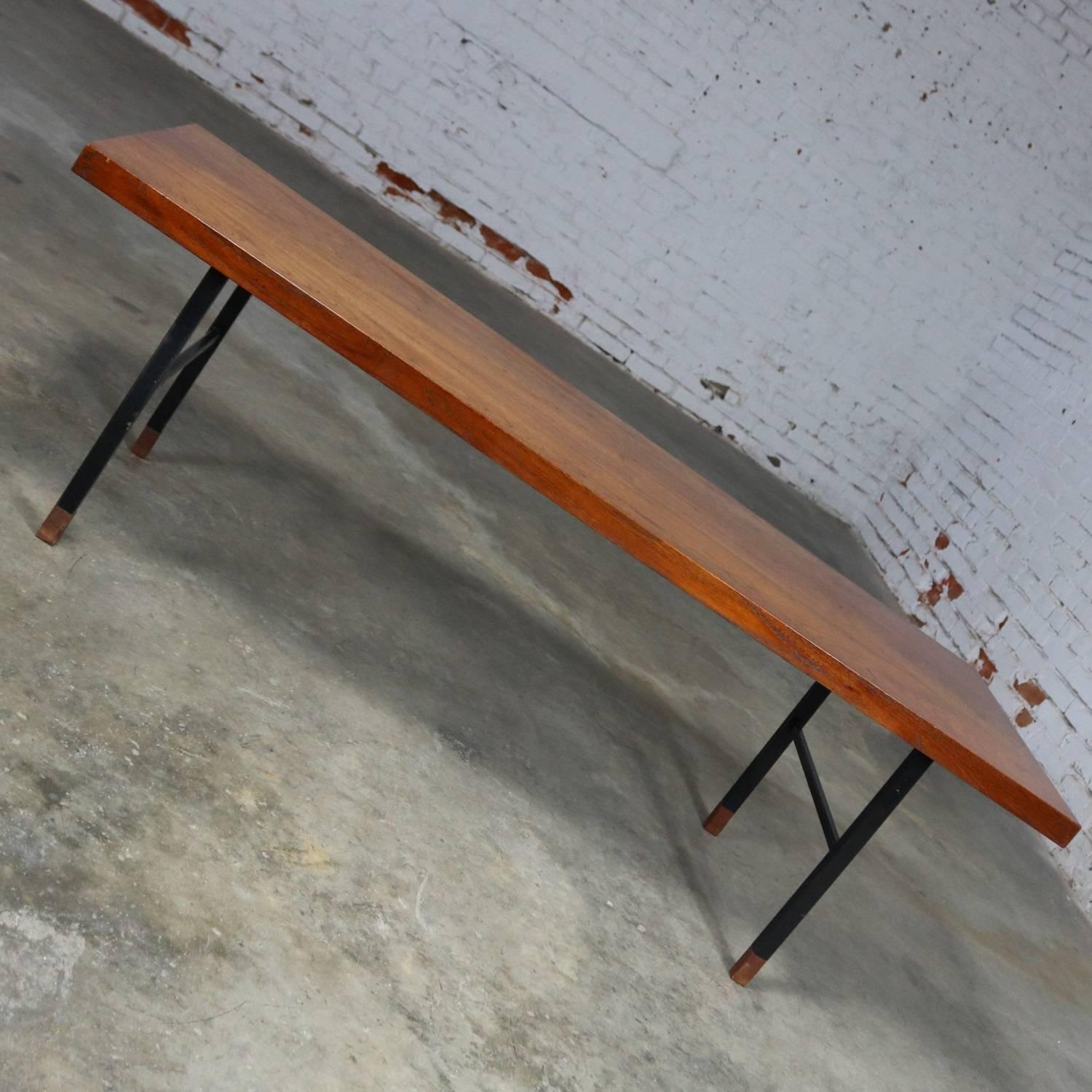 Handsome midcentury Scandinavian Modern coffee table with teak top and black painted metal H-base and teak feet. Stamped Made in Denmark on underside. In wonderful vintage condition apart from a small portion of a water spot we have been unable to