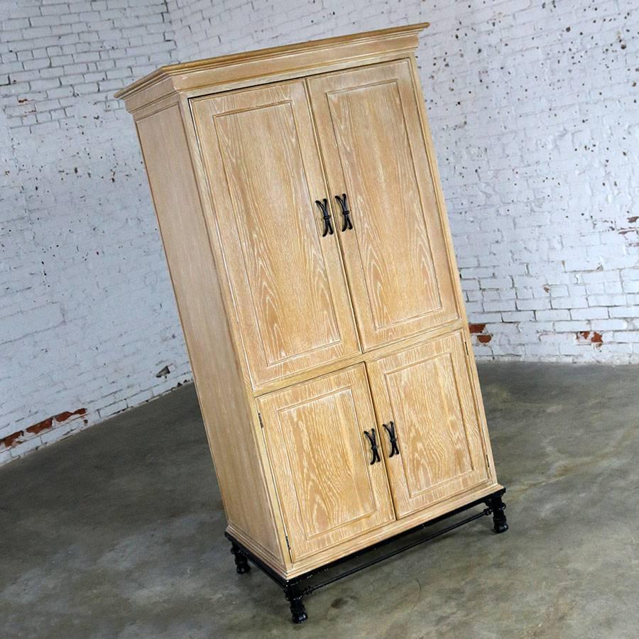Handsome tall white washed oak entertainment cabinet on a black steel base by Lane. In wonderful vintage condition, circa 1990.

Great looking cabinet by Lane Alta Visa Virginia. Originally made as an entertainment cabinet to conceal a TV but for