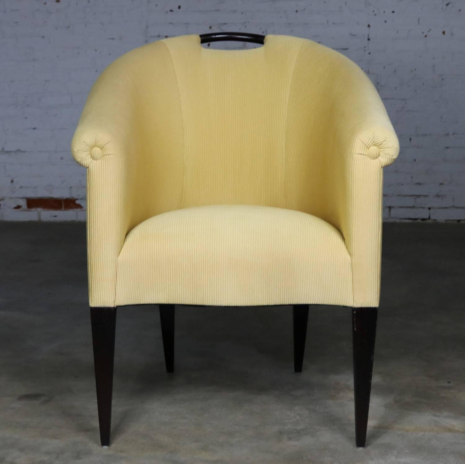 Incredible vintage Donghia barrel shaped armchair in yellow-gold corded upholstery and ebonized tapered legs and handle designed by John Hutton. It is in fabulous vintage condition and ready to use, circa late 20th century.

Sensual and delicate