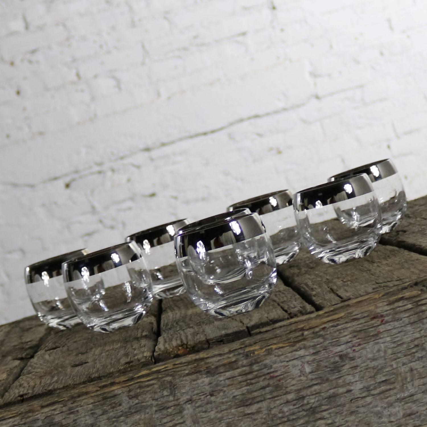 Awesome set of eight roly poly cocktail glasses with a silver – like rim in the style of Dorothy Thorpe. This set is in like-new condition, circa 1950s-1960s.

These roly poly cocktail glasses will look absolutely fabulous in your bar or on your