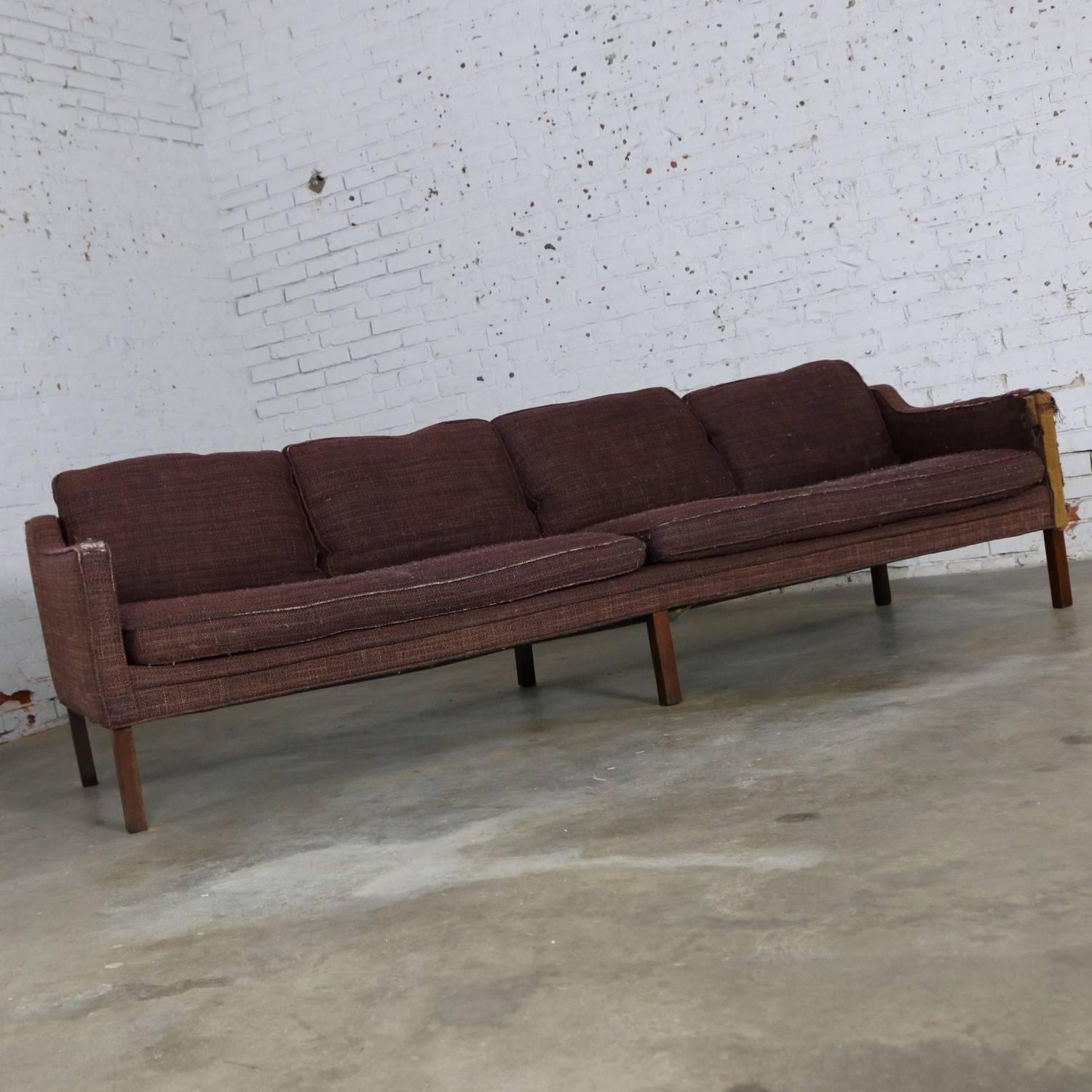 Thayer Coggin four seat Mid-Century Modern sofa frame by Milo Baughman. The upholstery is shot on this one, but the sofa frame is solid, and the lines are wonderful, circa 1960s-1970s.

Just look at the style and presence of this sofa! Even in its