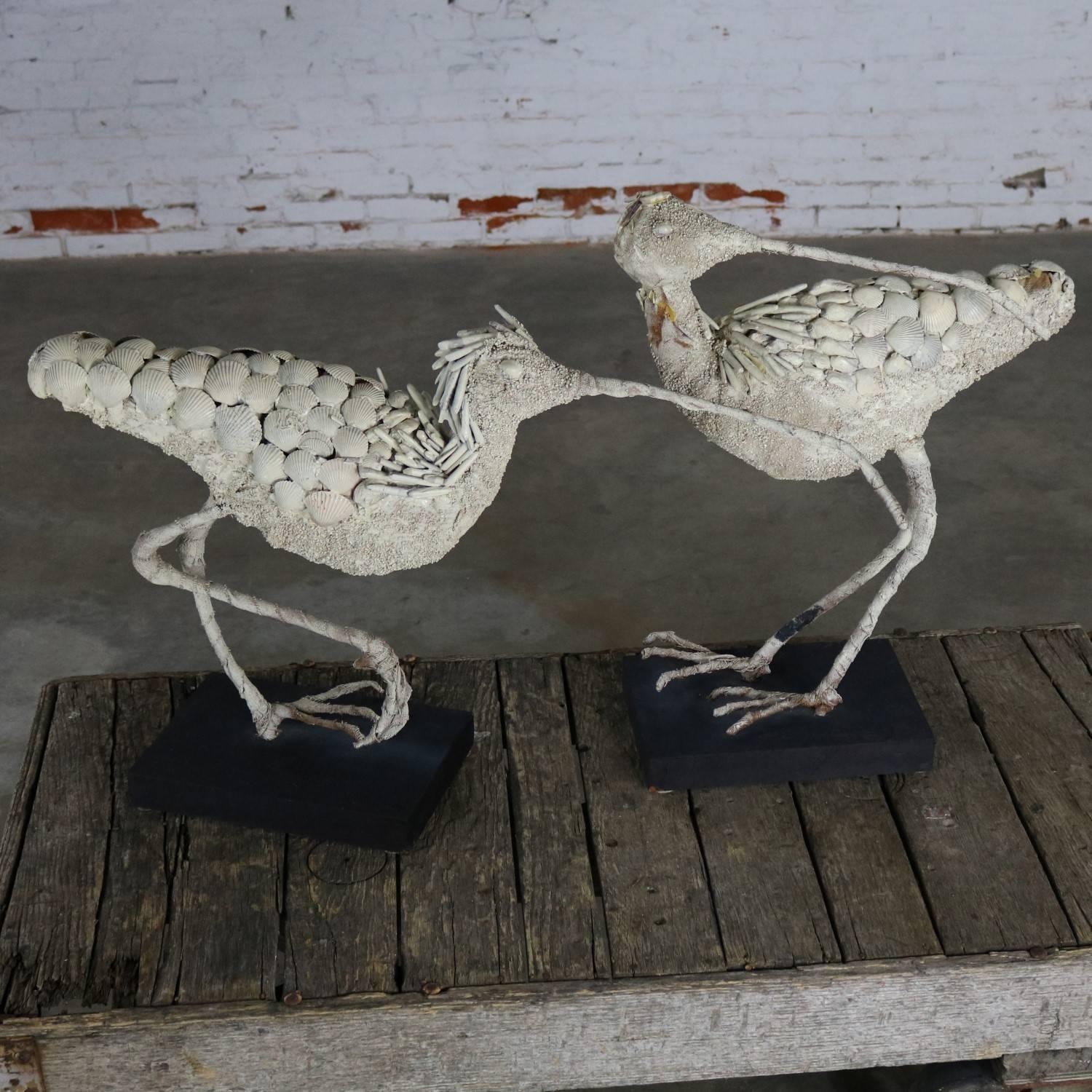 Monumental in size and style this pair of shell encrusted burlap and wire bird sculpture is sure to please. In sturdy condition with lots of awesome patina. circa 20th century.

If you are looking for an over-the-top centerpiece or monumental