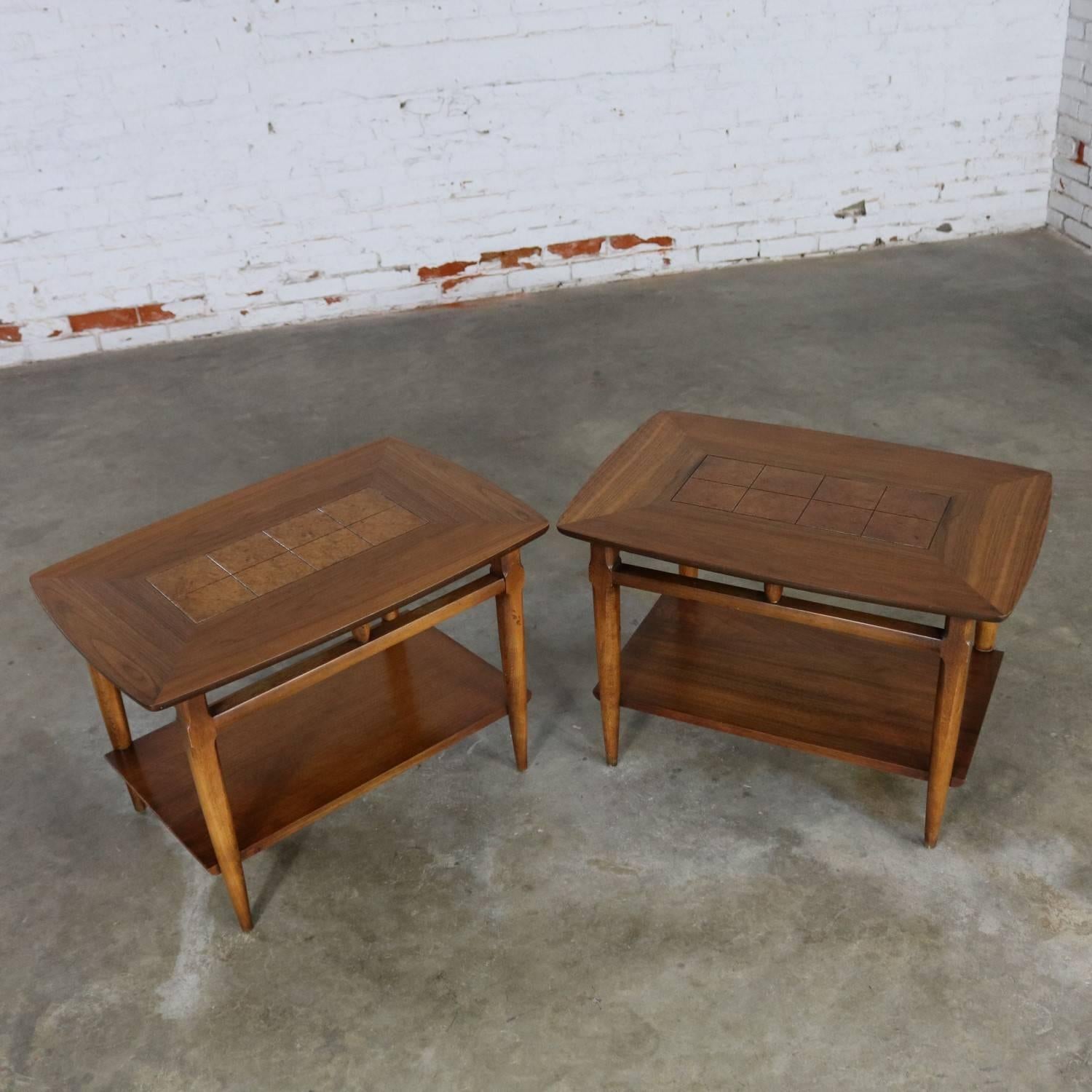 Beautiful pair of inlaid walnut Mid-Century Modern side or end tables style #1925 by Lane. They are in wonderful restored condition. The burled inlays are slightly different in color which is inherent of the burl. Dated November 15, 1958.

Lane