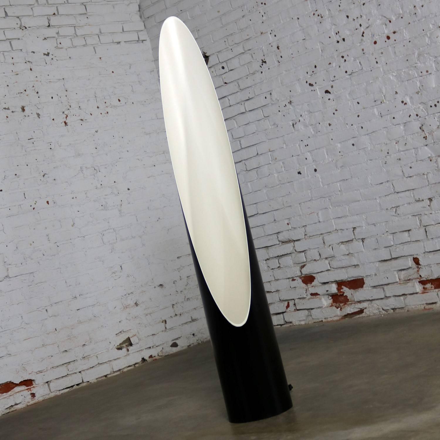 Incredible Mid-Century Modern or contemporary style cylinder floor lamp with a black exterior and a white interior having a diagonally cut opening giving it an elliptical efficacy of light. This lamp is in newly restored condition. circa 20th