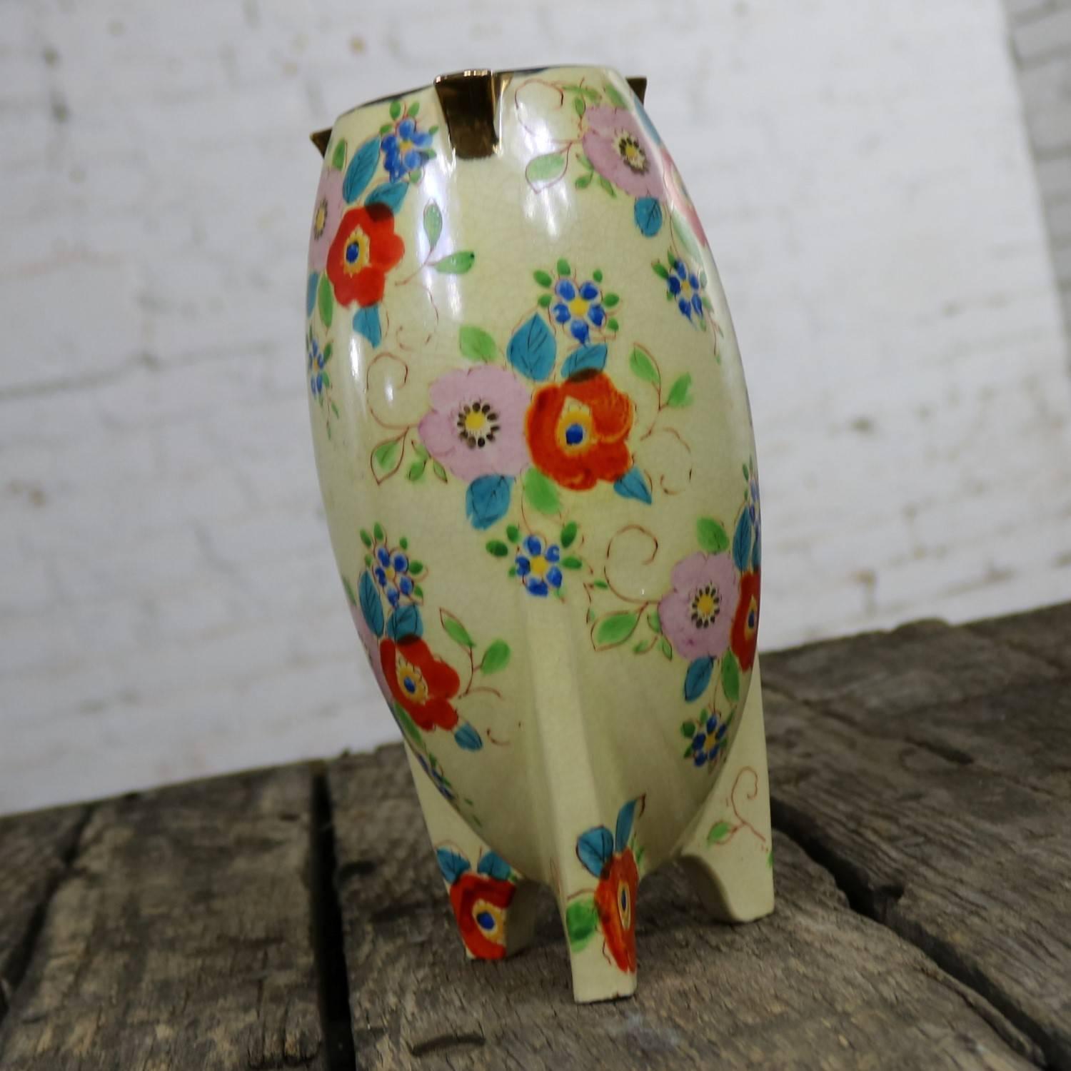 Beautiful Japanese bullet shaped or rocket shaped Art Deco lusterware vase in a floral design with gold accent. This vase is in wonderful vintage condition with no major flaws. There is a small chip to the underside of one of the feet. It does have