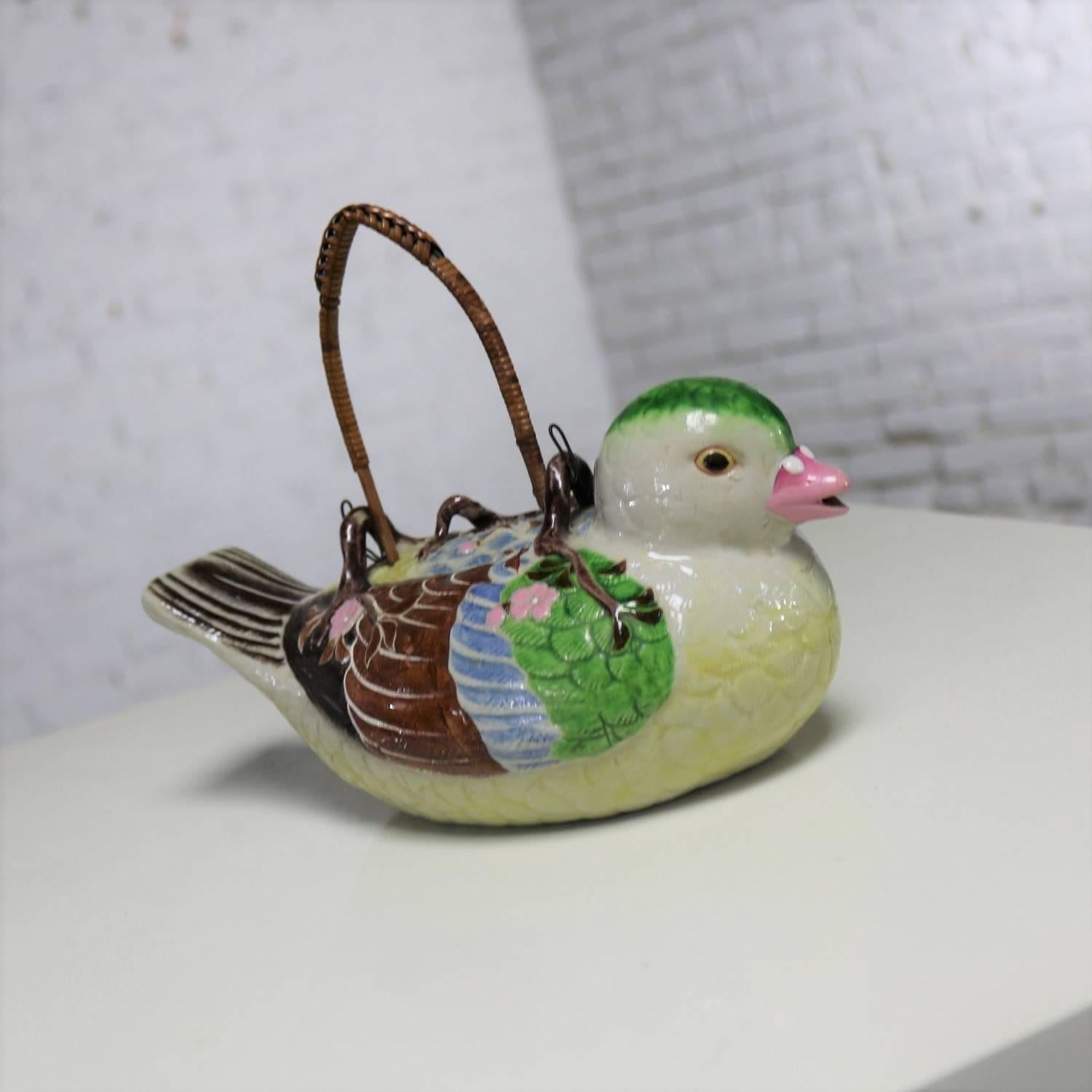 Charming Japanese Banko ware small figural teapot in the shape of a bird whistling, with wrapped rattan removable handle. In excellent condition with no chips, cracks or chiggers we have found, circa late 19th or early 20th century.

Such a