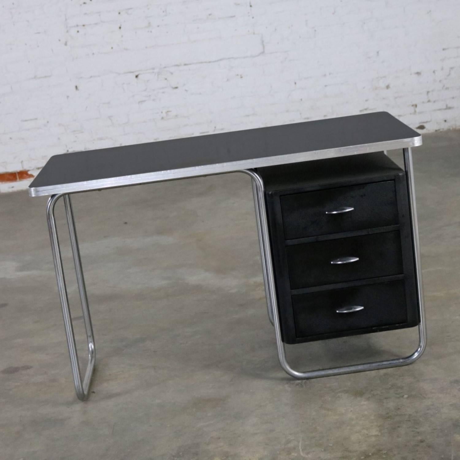 Phenomenal Art Deco, streamline moderne, Machine Age black and chrome desk by Walter Dorwin Teague for Texaco. It is in fabulous vintage condition but not without small imperfections you would expect for its age. The top surface has a spot where it